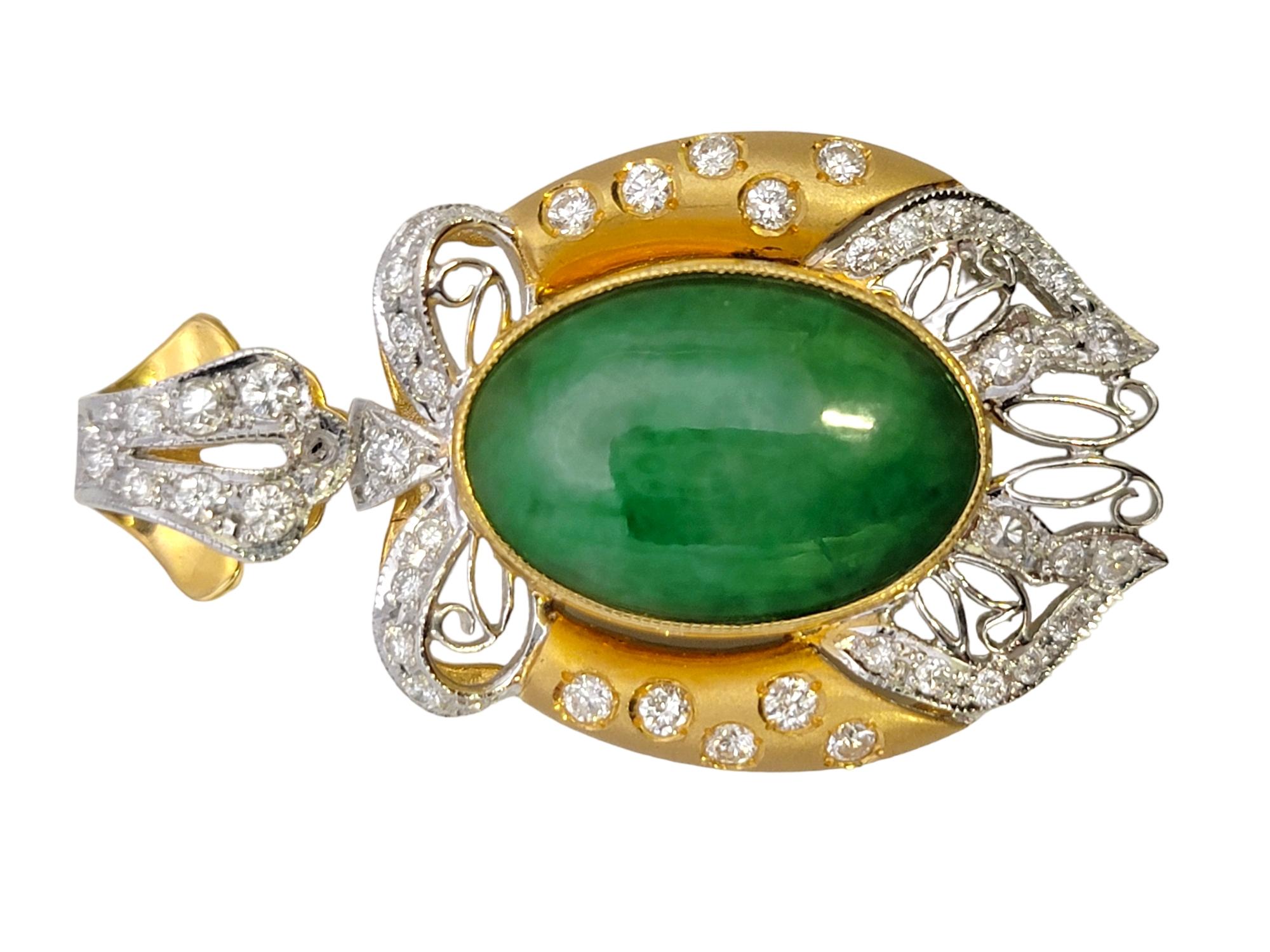 Intricately designed jade and diamond pendant with a gorgeous bow and filigree design. The sizeable pendant sparkles beautifully in the light while the bright green jade radiates among the elaborate setting. 

This lovely pendant features a single