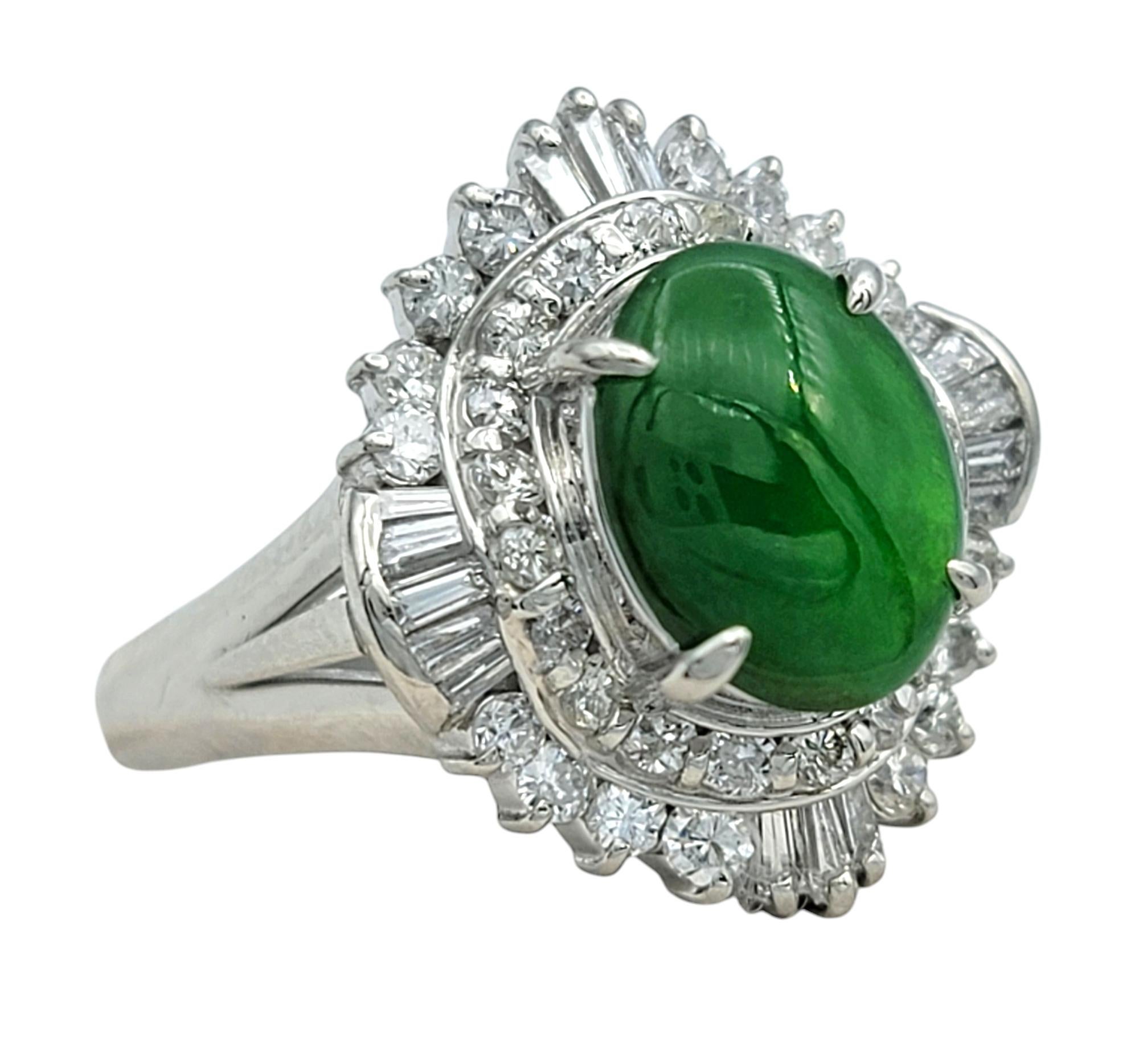 Ring Size: 5.75 

 A stunning blend of vintage charm and timeless elegance, this platinum ring features a mesmerizing oval jade center stone in a rich green hue. The exquisite jade is beautifully framed by a ballerina-style diamond halo, composed of