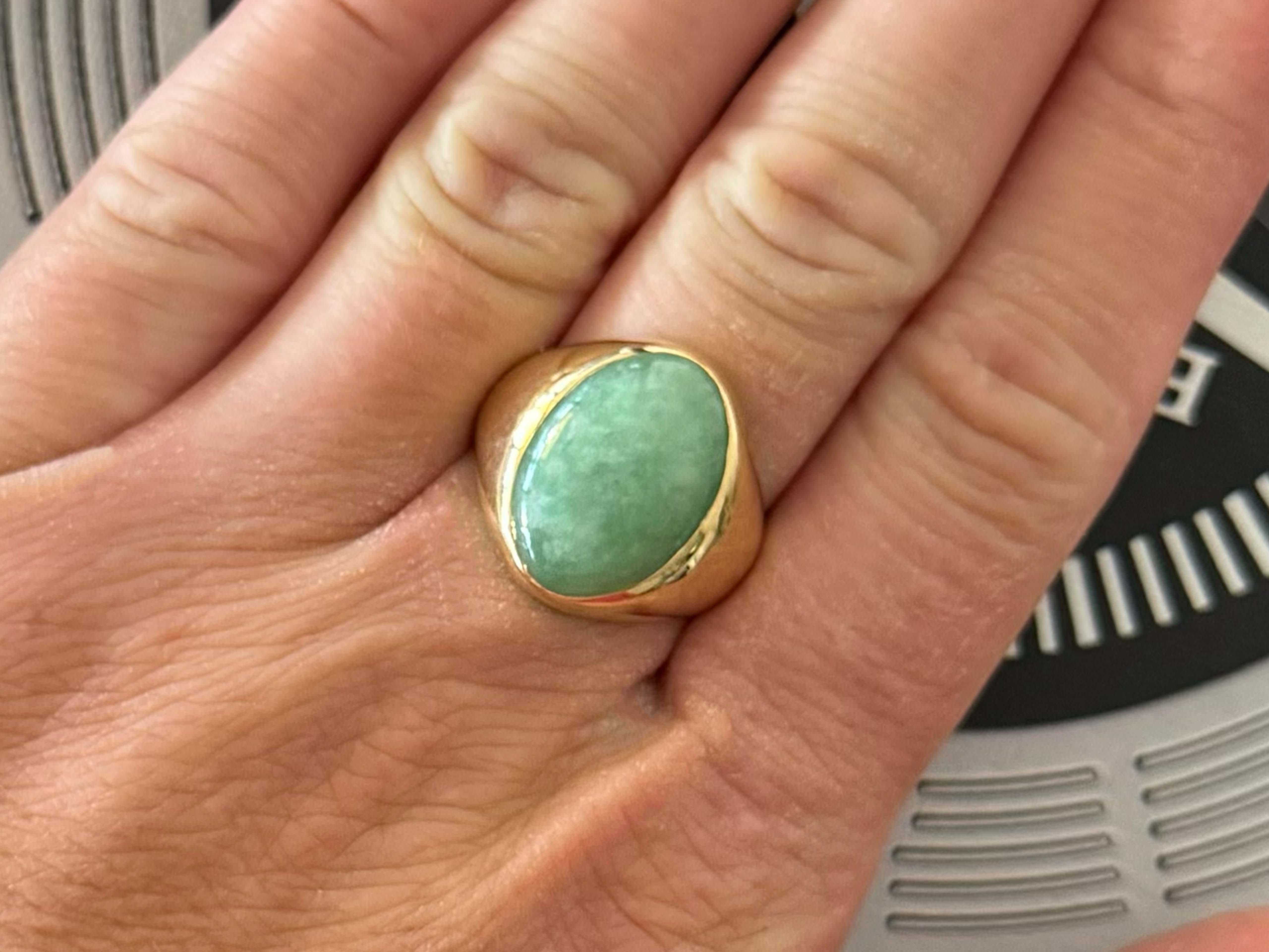 Item Specifications:

Metal: 14k Yellow Gold 

Style: Statement Ring

Ring Size: 8 (resizing available for a fee)

Total Weight: 8.1 Grams

Gemstone Specifications:

Center Gemstone: Jadeite Jade

Shape: Oval

Color:  Green

Jade Measurements: ~18