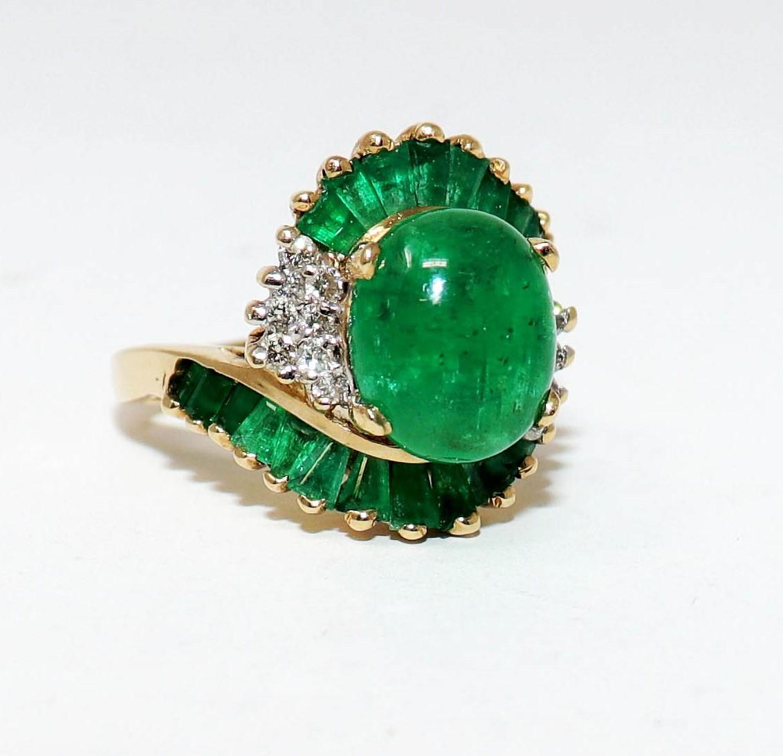 Ring size: 7.5

Bold and breathtaking, this ring has a stunning swirled design that brings elegant movement and big sparkle to the finger. 

Gorgeous piece features a stunning 4.75 carat oval cabochon cut Natural Emerald prong set as the centerpiece
