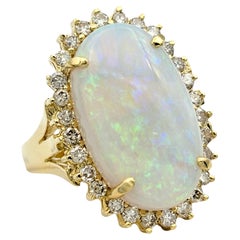 Oval Cabochon Opal Cocktail Ring with Diamond Halo Set in 14 Karat Yellow Gold
