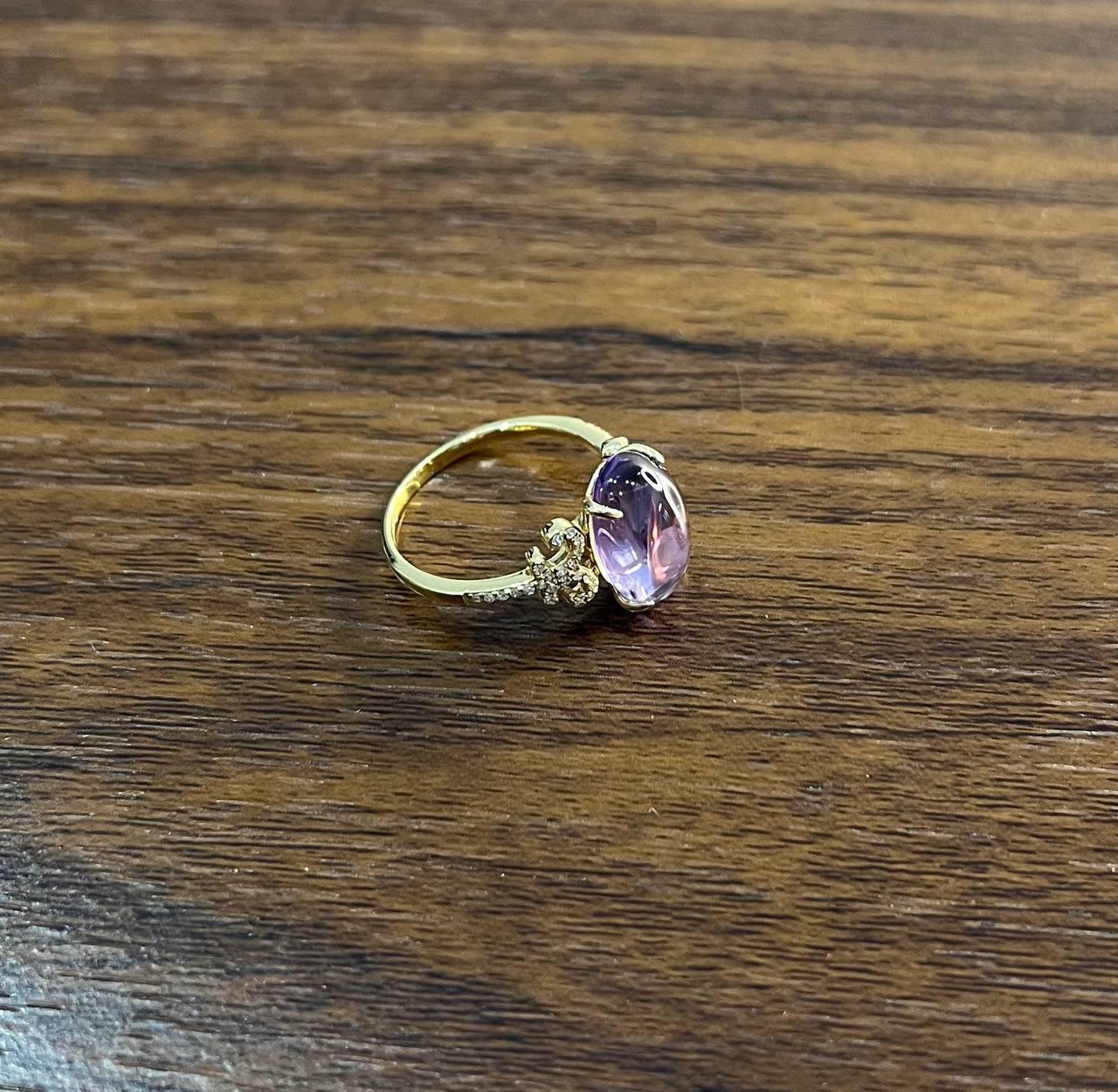 Eine Studie in Eleganz, Farbe und Brillanz.

Dieser auffällige Ring besticht durch einen rosa Amethyst im Cabochon-Schliff. Der glatte, runde Stein wird von einer Gruppe funkelnder weißer Diamanten flankiert, die in ein warmes 14-karätiges Goldband