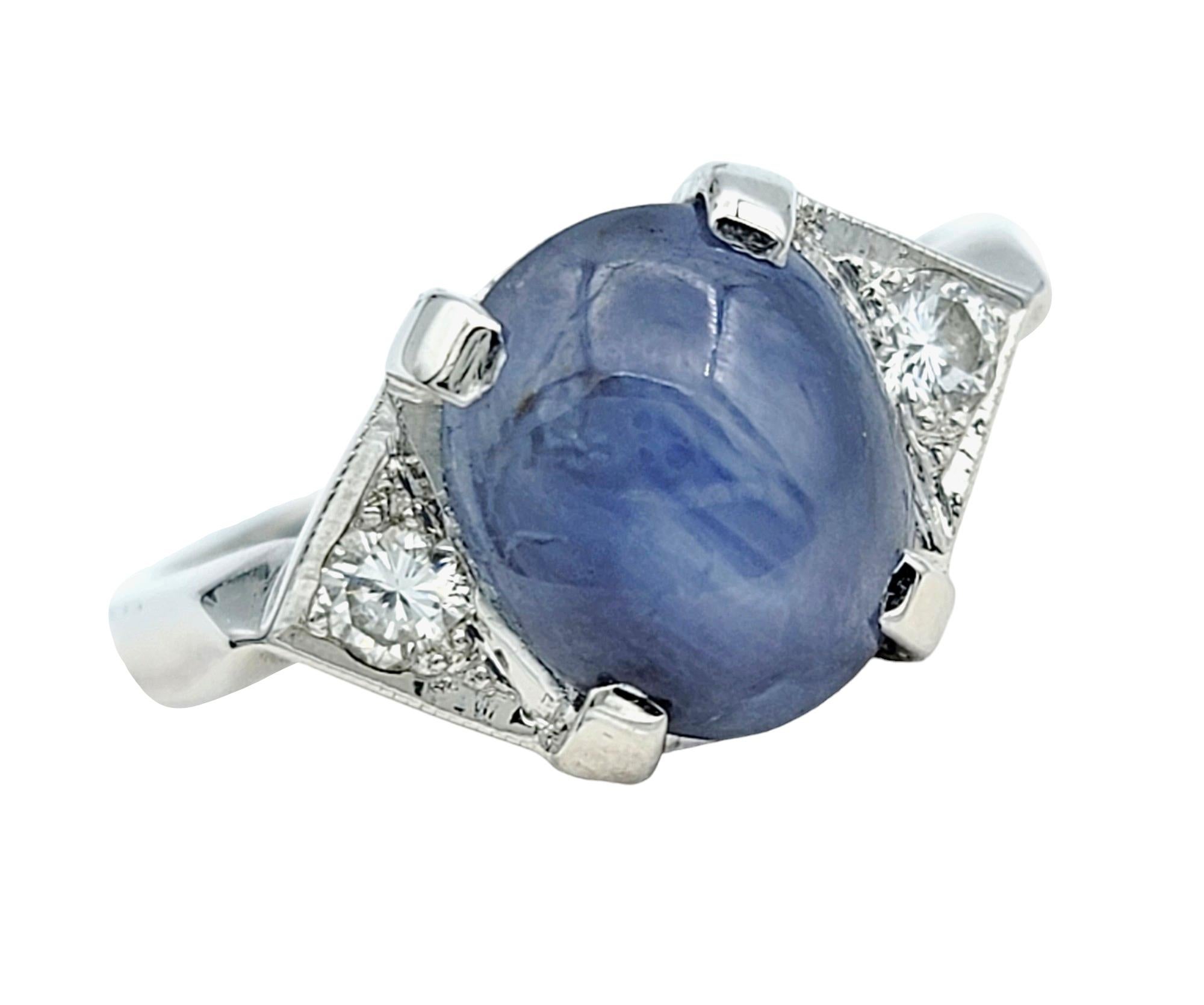Ring Size: 6.75

Crafted with impeccable artistry, this stunning ring features a captivating oval cabochon star sapphire as its centerpiece, exuding celestial allure and mystique. The star sapphire, with its enchanting asterism that dances across