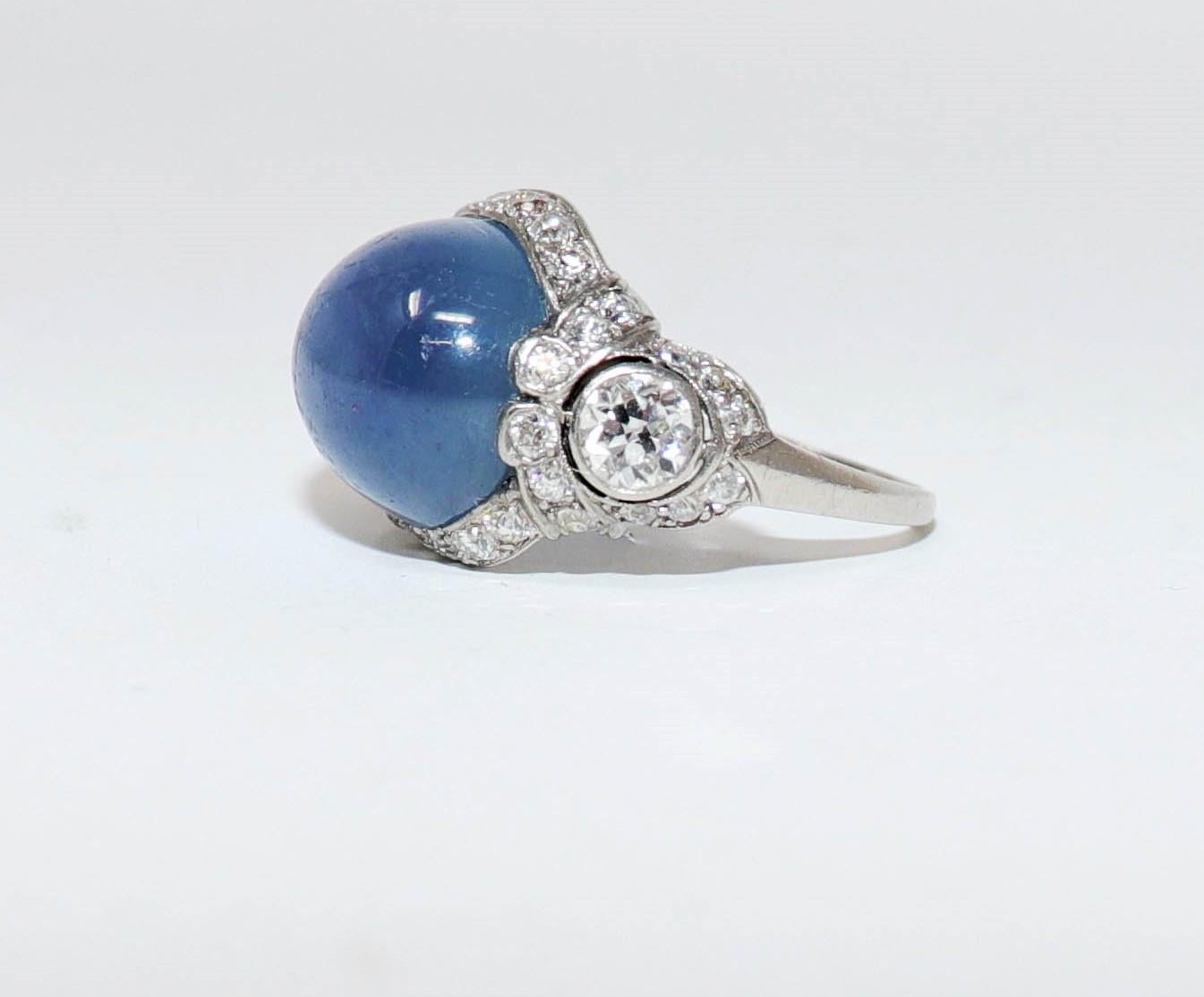 Ring size: 6

This rare star sapphire cocktail ring is an absolute showstopper. It features a stunning, high polished blueish-purple oval cabochon stone, surrounded by a sparkling halo of icy white diamonds. This magical stone shimmers beautifully