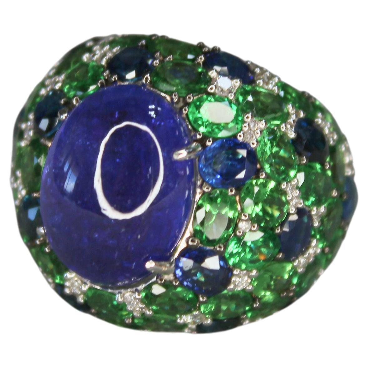 Oval Cabochon Tanzanite Tsavorite Diamond Pave Dome Big 18K White Gold Ring
18 Karat White Gold
Genuine Tanzanite, Blue Sapphires, Tsavorites and Diamonds
15.00 cts Oval-Cabochon Shape Tanzanite
4.50 cts Green Tsavorites
2.15 cts Blue Sapphires
0.50