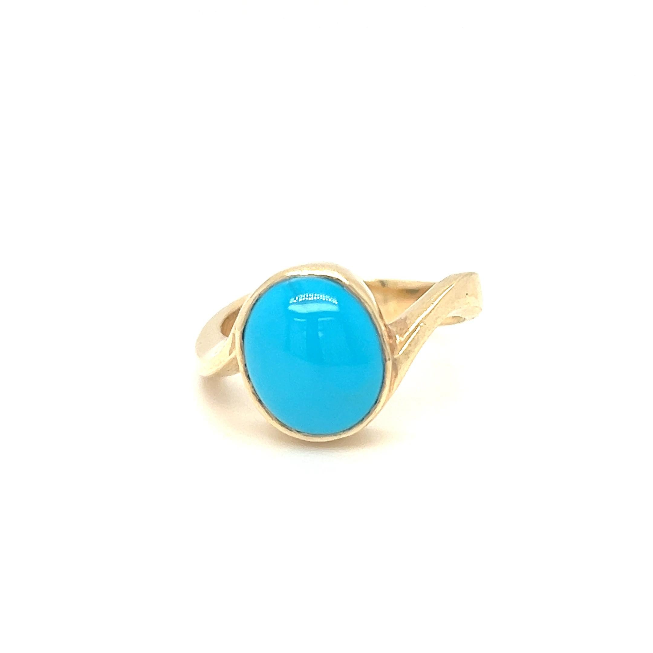 This vivid blue oval-shaped turquoise ring is elegantly set in a 14k yellow gold bezel setting. With a ring top measuring 10 x 12.4 mm, the rich hue of the turquoise beautifully contrasts with the warm yellow gold, creating a striking and