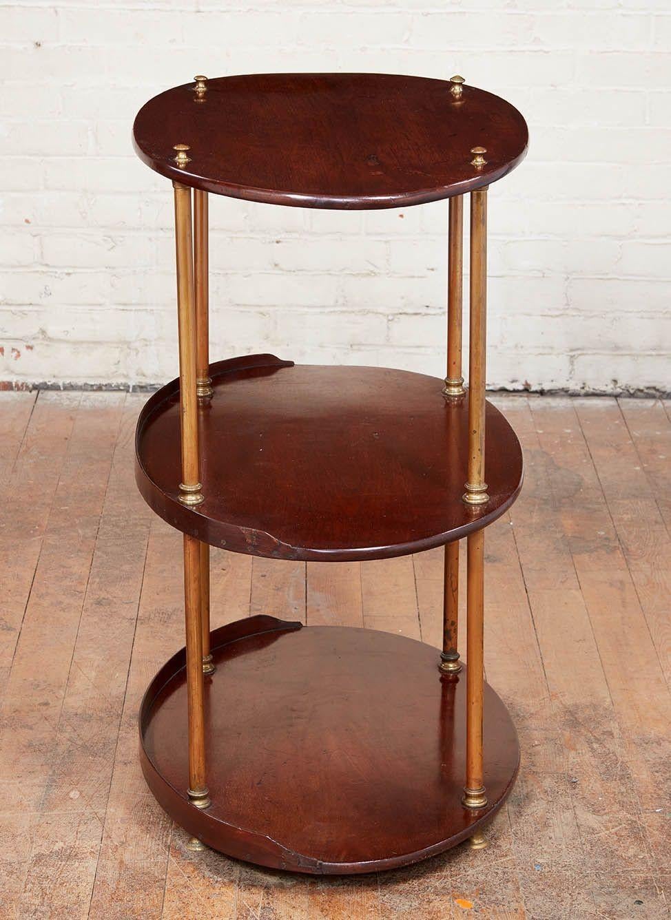 English mahogany oval campaign etagere, the three oval mahogany shelves supported by brass columns with original molded collars.
