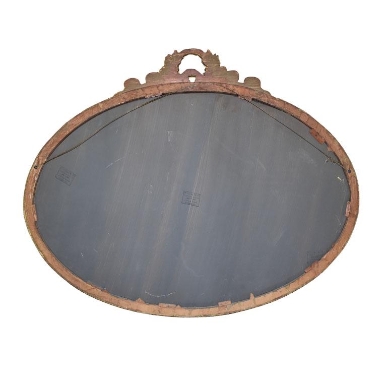 A beautiful way to add a touch of elegance to any space. This oval mirror is created from wood and features carved vines and floral reliefs. A hanging wire is attached at back for easy installation. 

Dimensions:
38.5