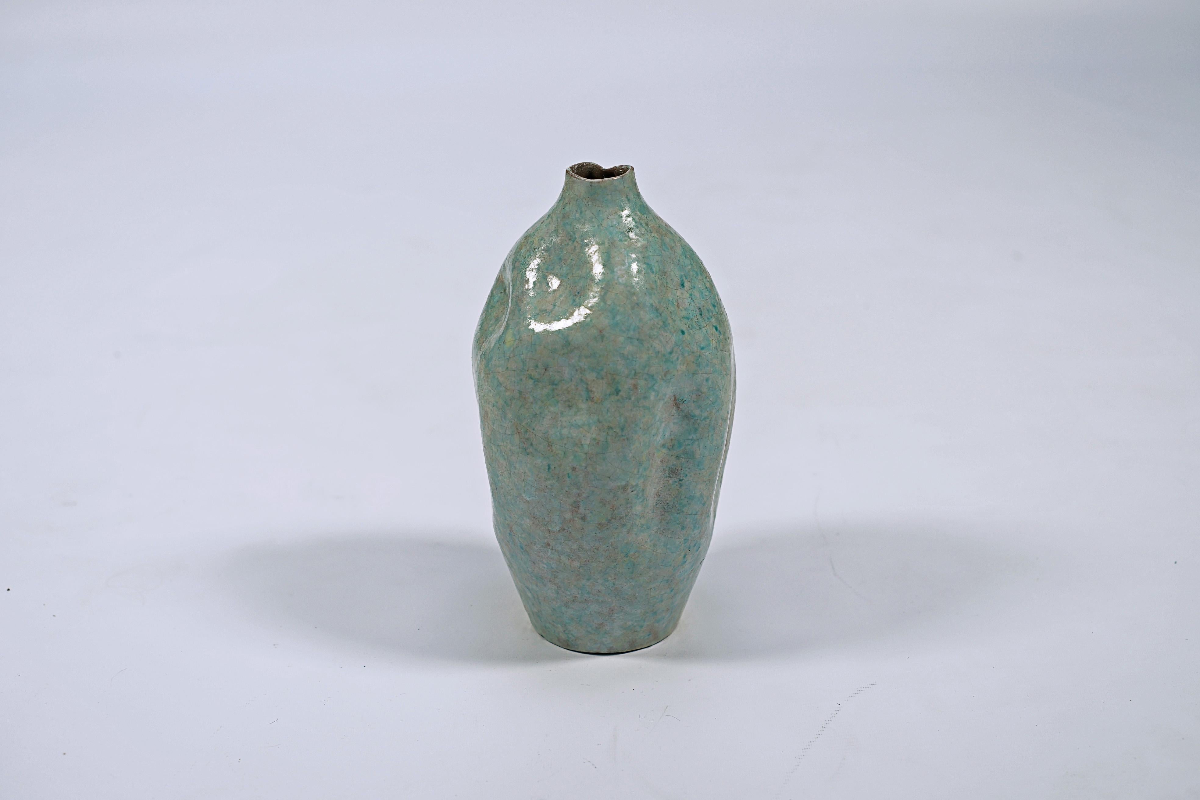 Oval ceramic vase with dent texture, in light blue, pink and yellow tones. By Marcelo Fantoni (1915-2011), Signature Stamp, Fantoni, Made Italy

Italy, CIRCA 1950.