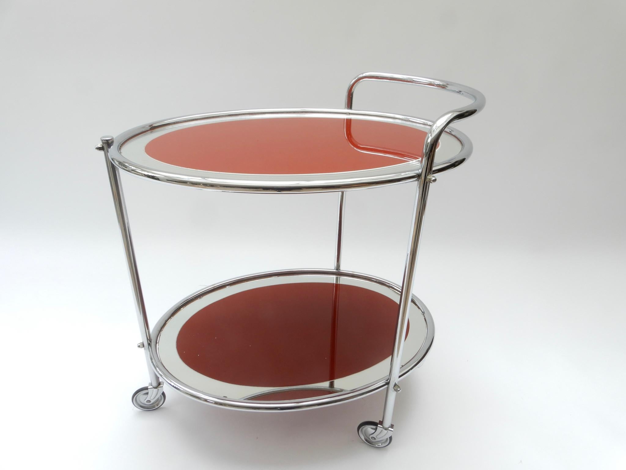 Oval chrome and rust glass mirrored bar cart, 1950s.