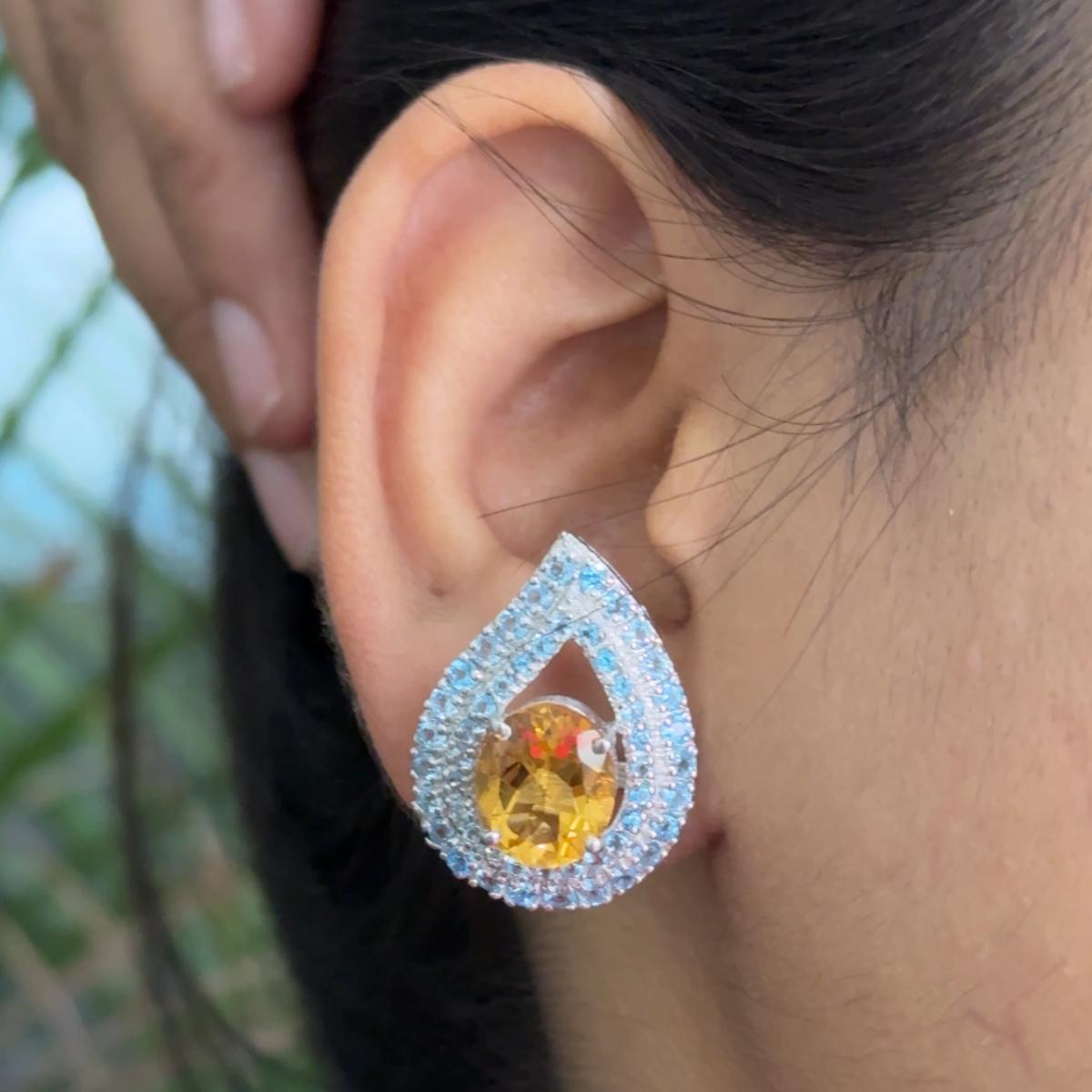 These gorgeous Citrine and Blue Topaz Reversed Pear Stud Earrings are crafted from the finest material and adorned with dazzling citrine and blue topaz where blue topaz improves communication and self-expression and citrine which is associated with