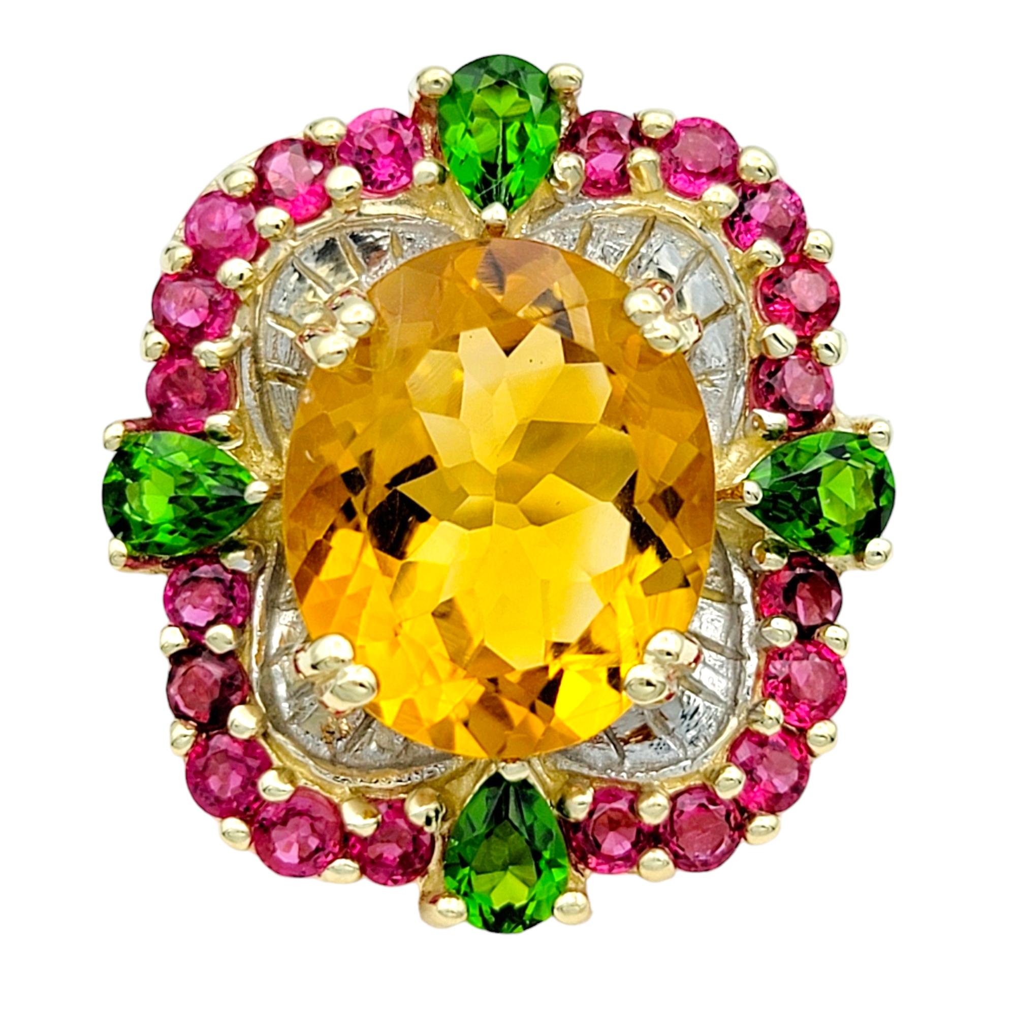 Ring Size: 6.5

This stunning ring showcases a vibrant blend of gemstones set in 14 karat yellow gold, creating a captivating and colorful design. At its center is a large oval citrine, radiating warmth and brilliance. Surrounding the citrine is a
