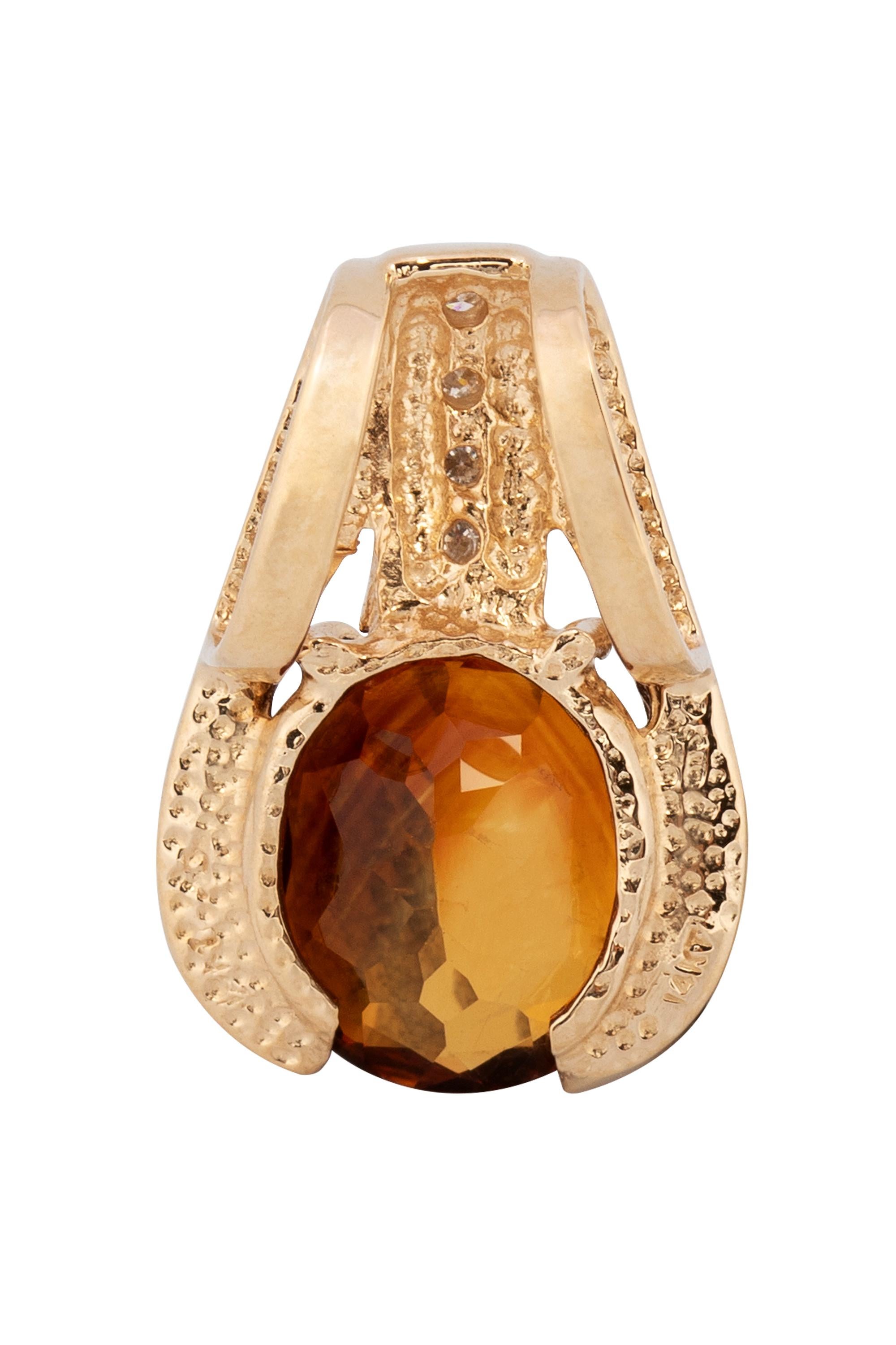This modern pearl enhancer features a deep amber color faceted citrine set in brightly polished 14 karat yellow gold and elevated by a channel set line of four round brilliant cut diamonds weighing approximately .12 carats in total. Measuring 7/8”.