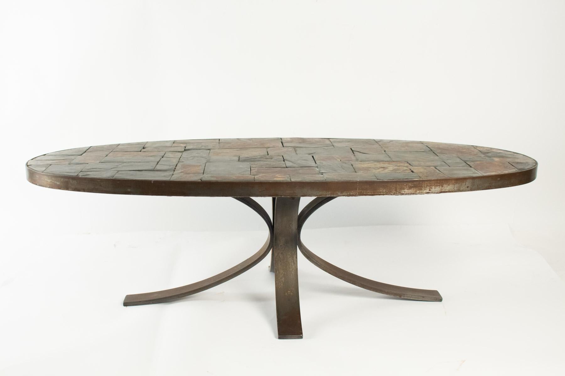 Oval coffee table in wrought iron and stone from the Ardoise, circa 1960-1970.
Measures: H 33cm, L 110cm, P 50cm.
 