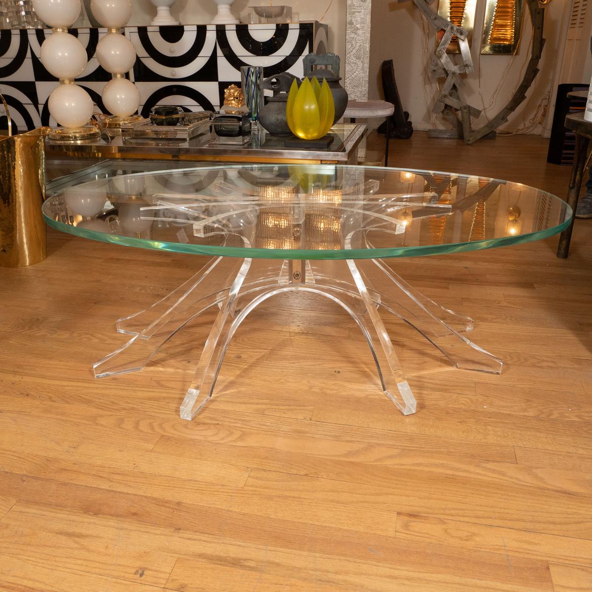 Oval coffee table with Lucite star form base with glass top.