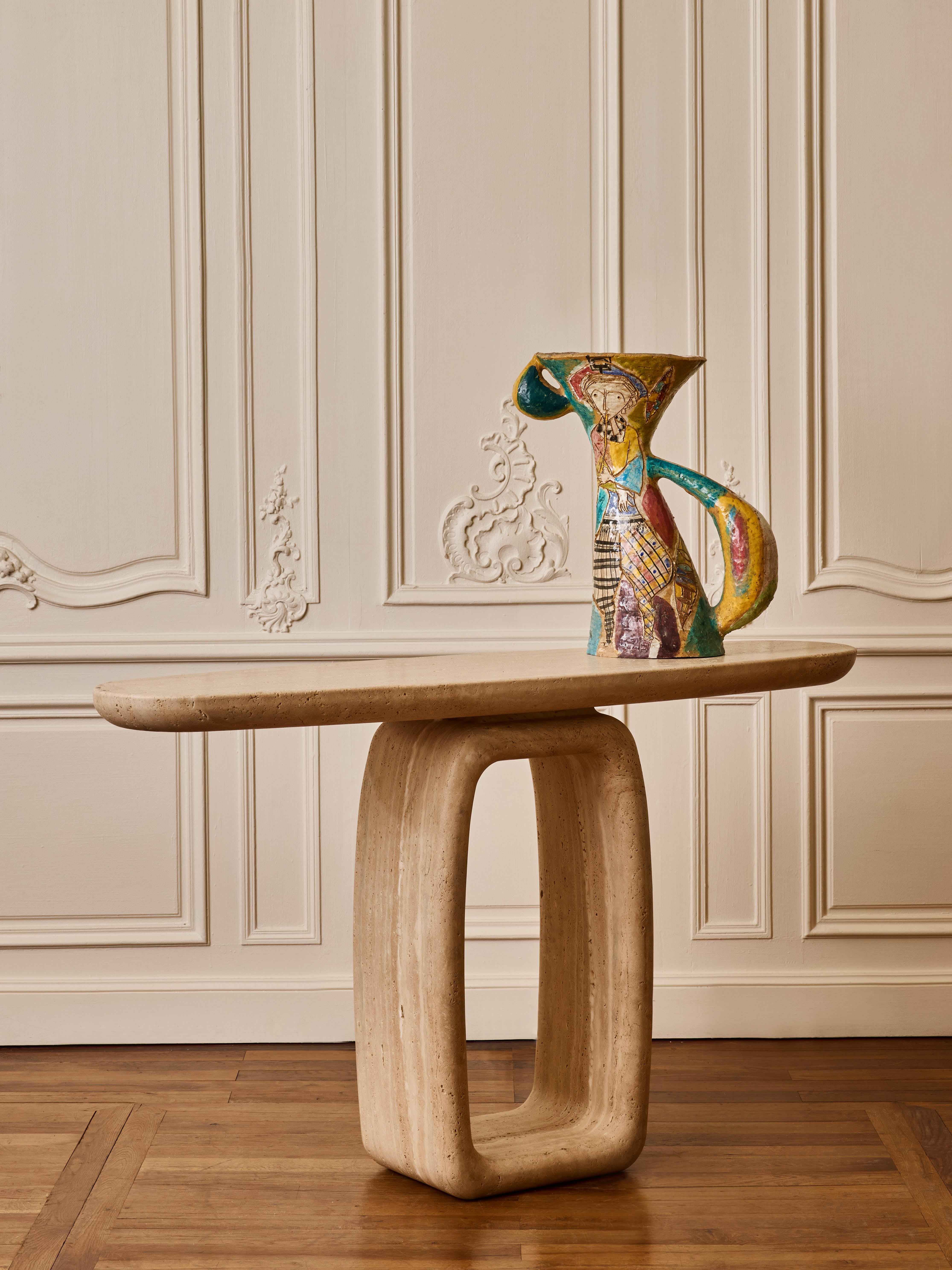 Console in massive travertine stone with base in oval shape.
France, 2024.