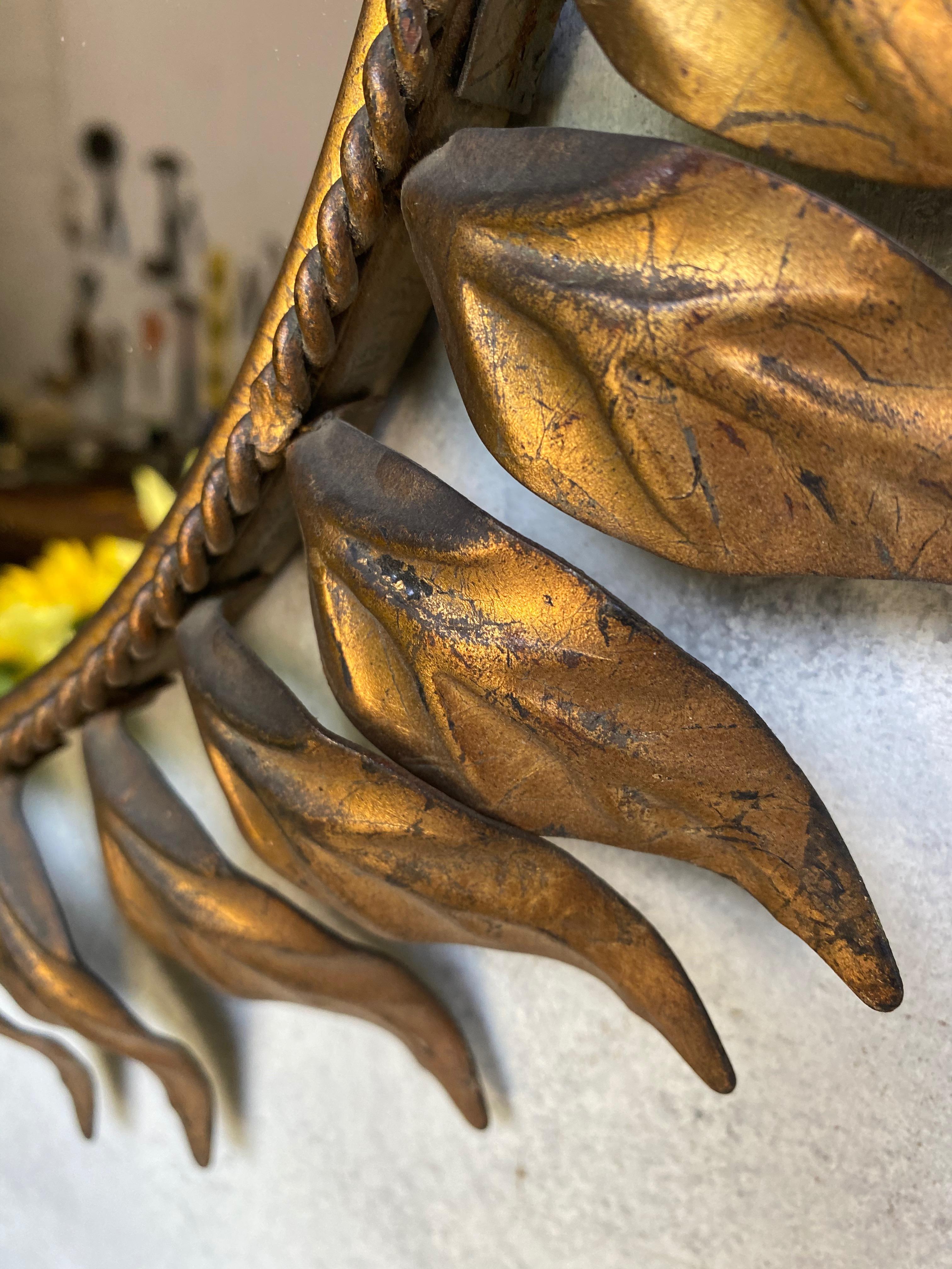 Mid-20th Century Spanish Oval Gilt Metal Sunburst Mirror with Curved Leaves For Sale