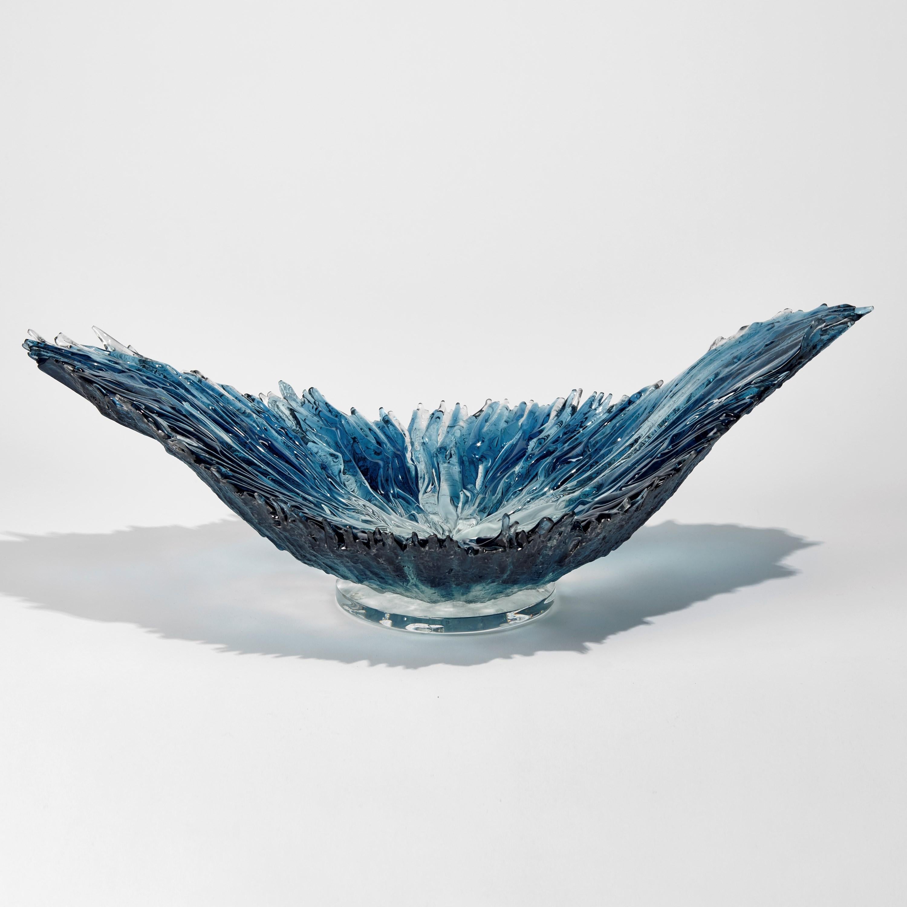 Oval Coral Bowl in Aqua is a blue / turquoise / aquamarine and clear glass organic centrepiece / bowl by the British artist Wayne Charmer. Combining drama, movement and scale, the glass resembles an impact splash in to water, simply stunning. It is