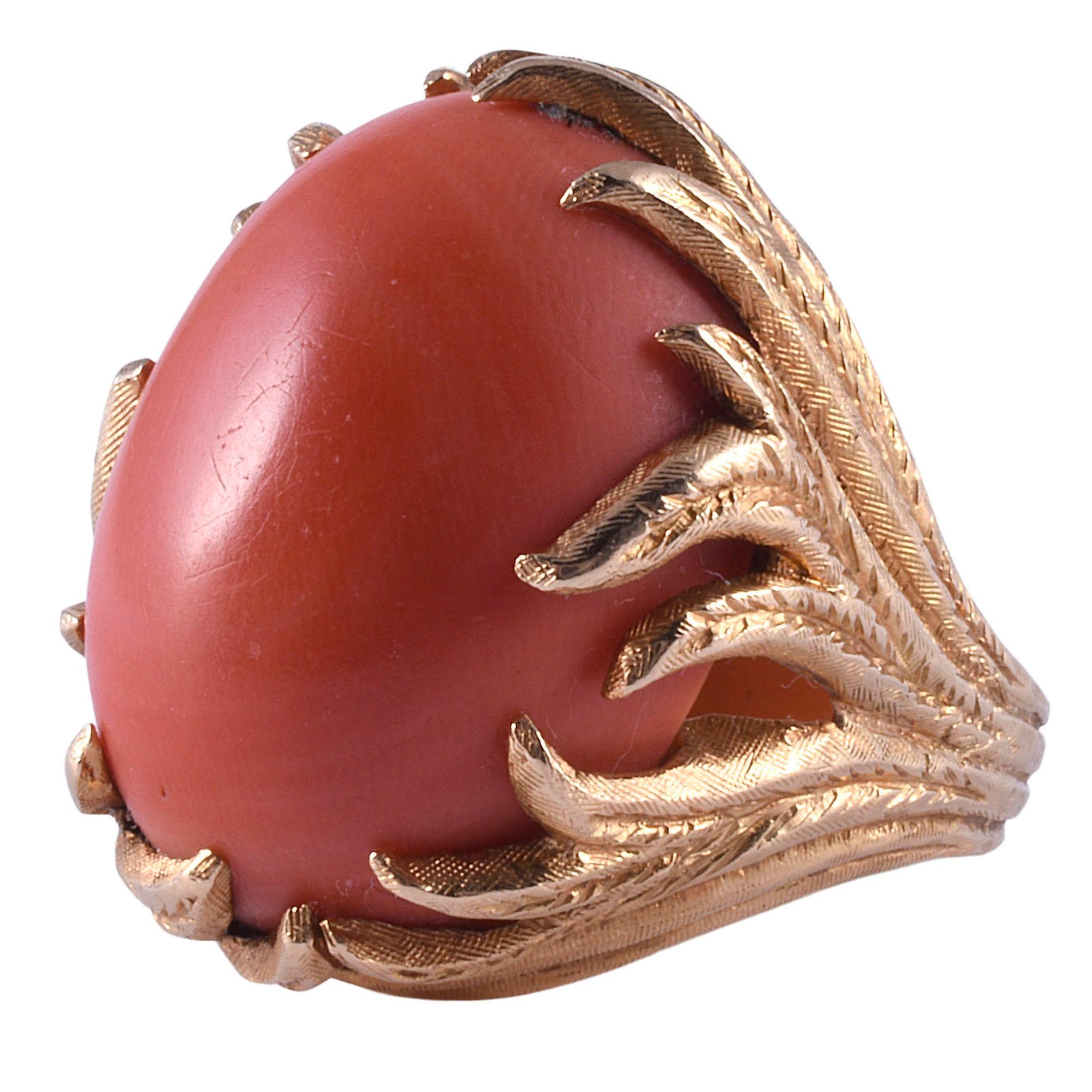 Vintage oval coral ring in hand engraved setting, circa 1970. This vintage ring is crafted in 14 karat yellow gold with hand engraving. It features a large oval coral measuring 24mm H x 18mm W x 11.1mm D. This ring is a size 7.75. [KIMH 617]