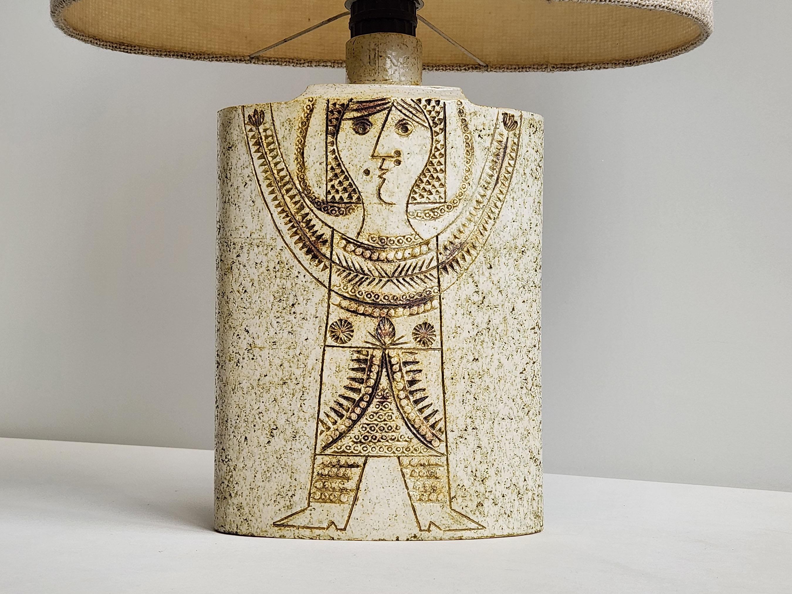 Carved 'sun goddess' design hand-glazed in cream and moss by master ceramist Roger Capron.