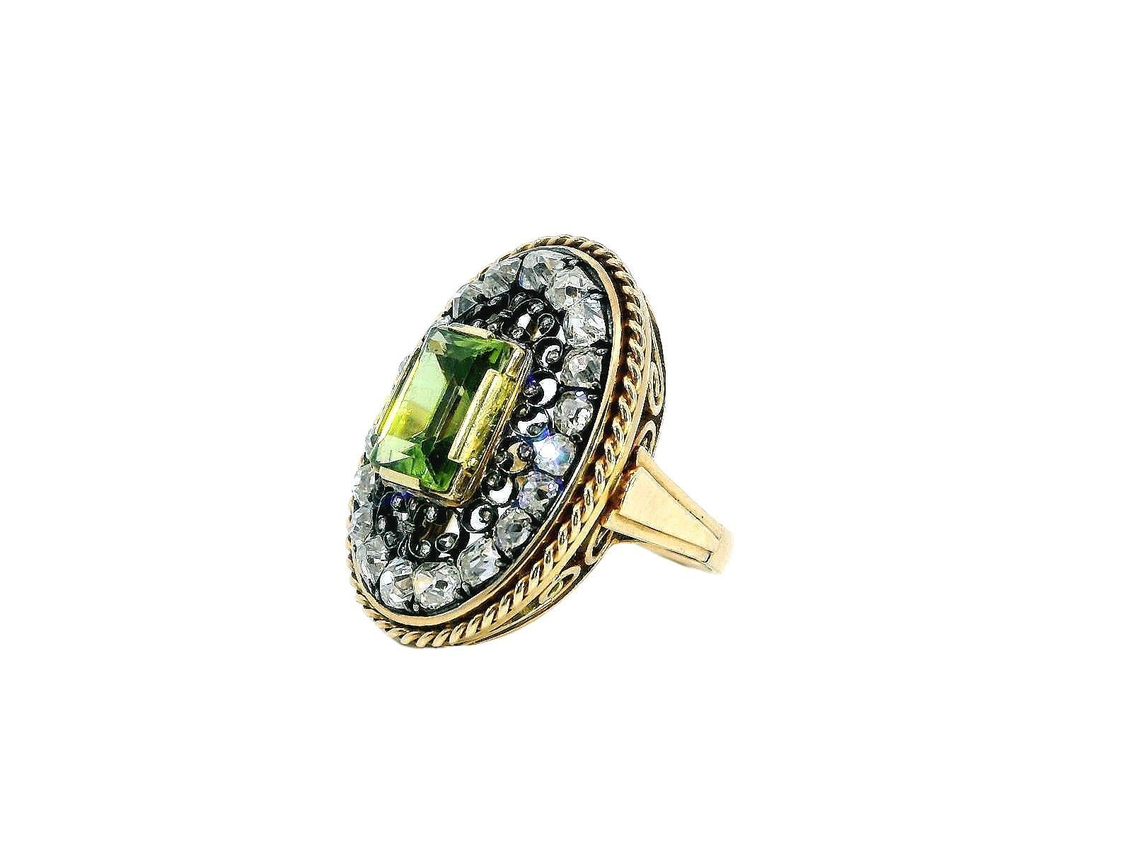 This exquisite ring showcases a remarkable 4.14-carat emerald-cut peridot, which boasts a vivid green hue that captivates the eye. Surrounding the peridot, 3.5 carats of mixed-cut diamonds add a touch of elegance and sparkle, enhancing the overall