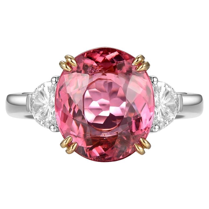 This ring features a oval cut 4.47 carat pink tourmaline, assented with 2 fancy cut diamonds on the shoulder. Each diamond weight 0.24 carat. The two diamonds are E color and VS clarity. A modern yet classic design. Tourmaline is set in 18 karat
