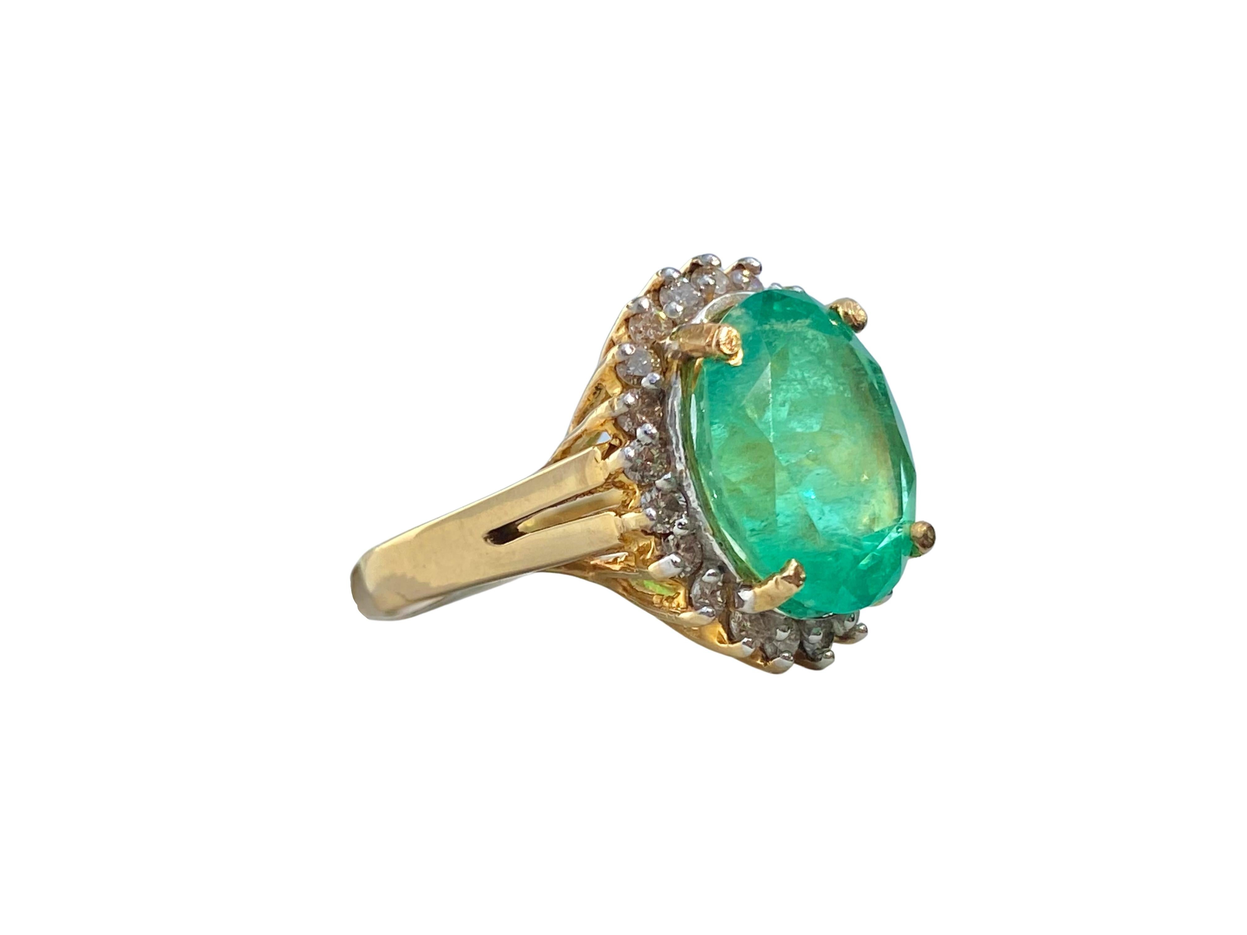 Centering a 6.88 Carat Oval-Cut Colombian Emerald, framed by 1.65 Carats of Round-Brilliant Diamonds, and set in 14K Yellow Gold. 

Details:
✔ Stone: Emerald
✔ Center-Stone Weight: 6.88 carats
✔ Stone Cut: Oval
✔ Stone Color: Vivid Green
✔ Stone