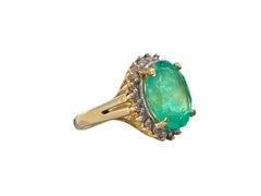 Oval-Cut 6.88 Carat Colombian Emerald, Diamond and 14K Yellow Gold Ring