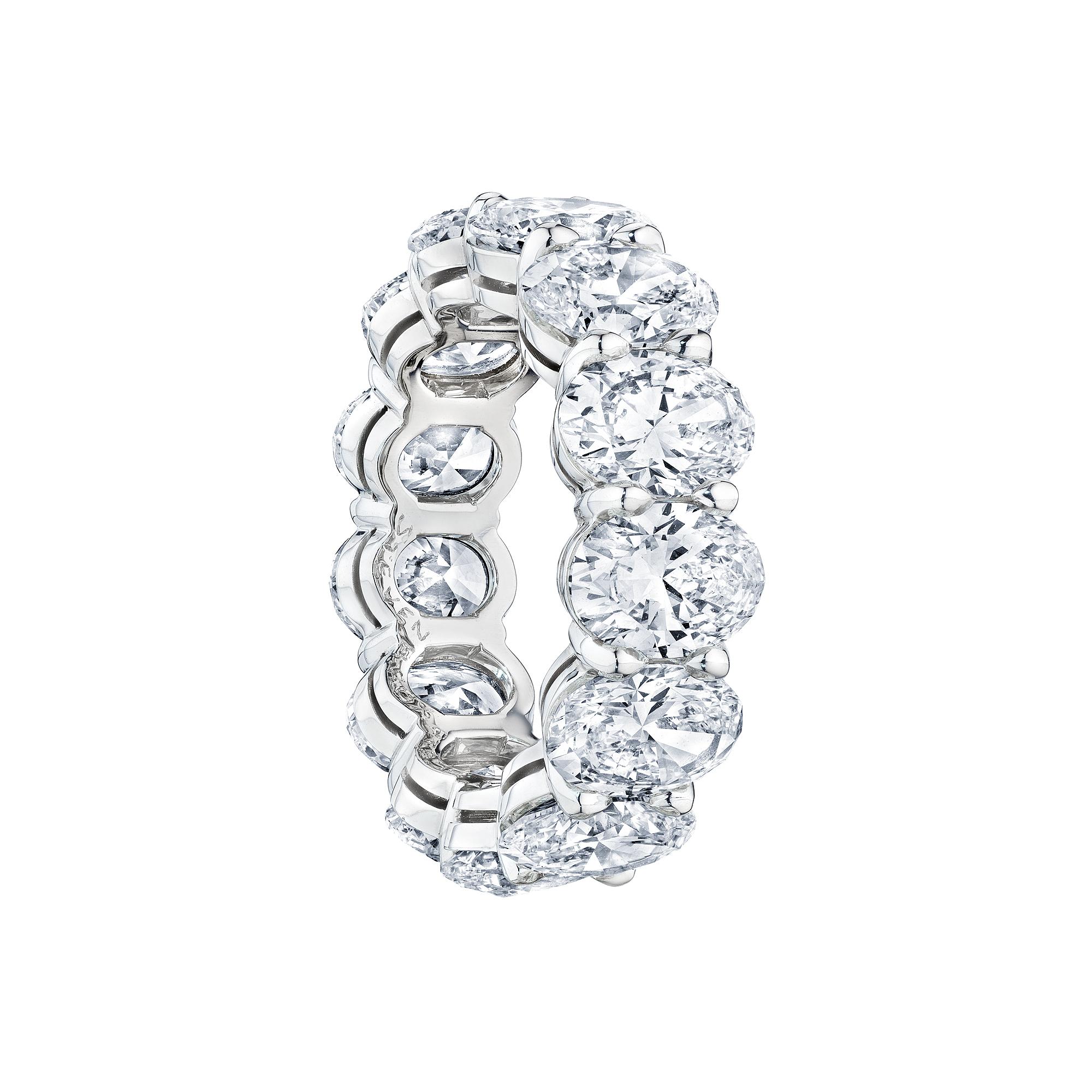 Oval bodied.  With 13 incredible matching oval brilliant cut diamonds elegantly standing side by side, this one-of-a-kind diamond and platinum eternity band has visual strength and a timeless spirit.  Total diamond weight is 9.55 carats.  D-F color.