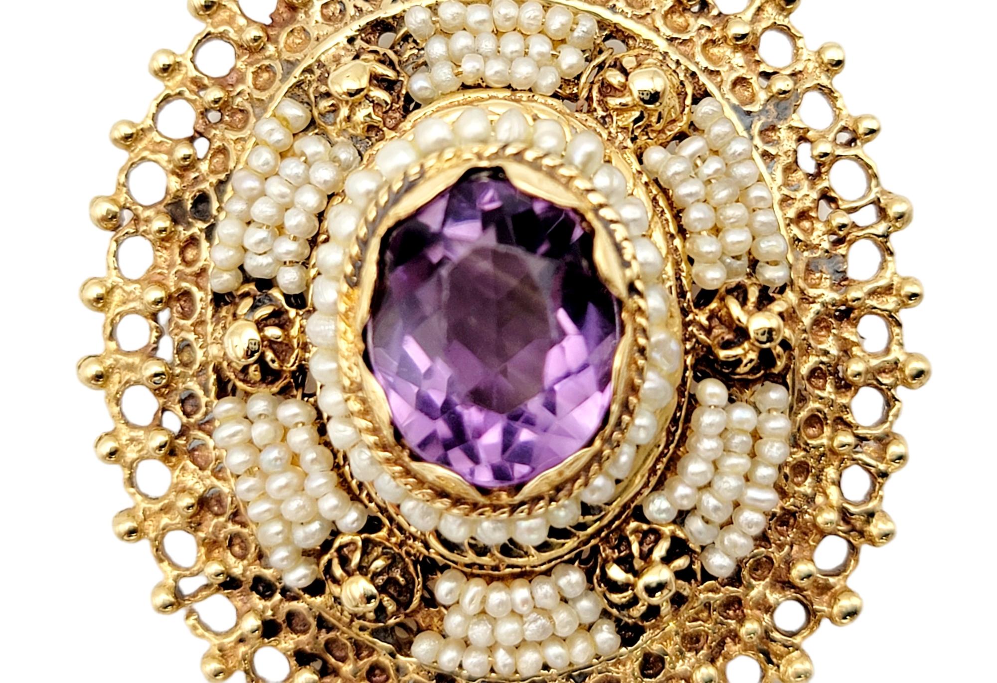 Charming amethyst and pearl brooch/pendant surrounded by a beautifully detailed 14 karat yellow gold filigree design.

Type: Brooch / Pendant
Metal: 14K Yellow Gold 
Natural Amethyst: 2.68 ctw 
Amethyst Cut: Oval
Amethyst color: Medium Light