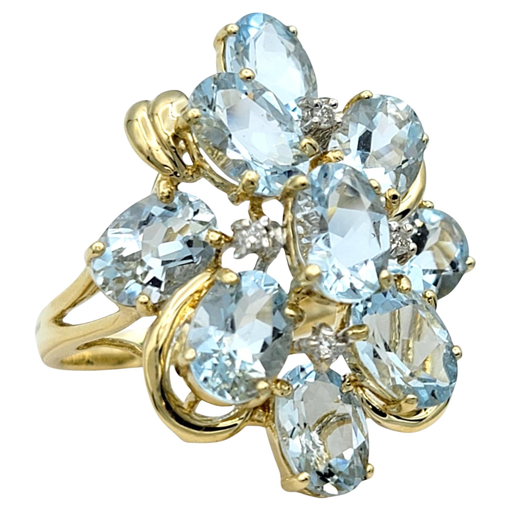Ring Size: 6.25

This enchanting aquamarine and diamond ring is a true masterpiece of elegance and brilliance. The centerpiece is a stunning cluster of multiple oval-cut aquamarines, each radiating a luminous light blue hue reminiscent of a serene