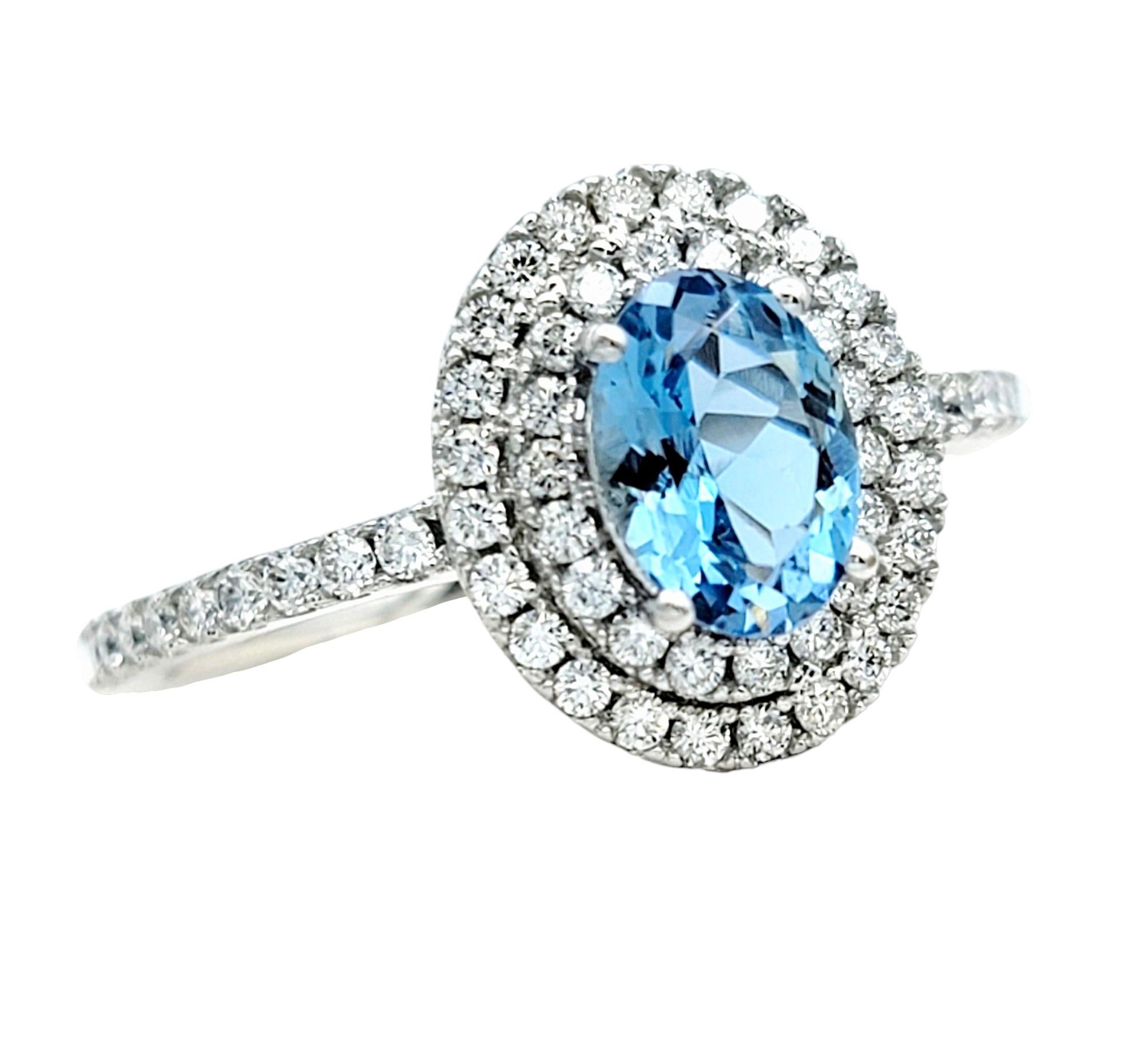 Ring Size: 7

This exquisite ring is a testament to timeless elegance and refined sophistication. Nestled at its heart is a captivating oval aquamarine, its serene blue hue reminiscent of tranquil waters, set meticulously in 18 karat white gold. The