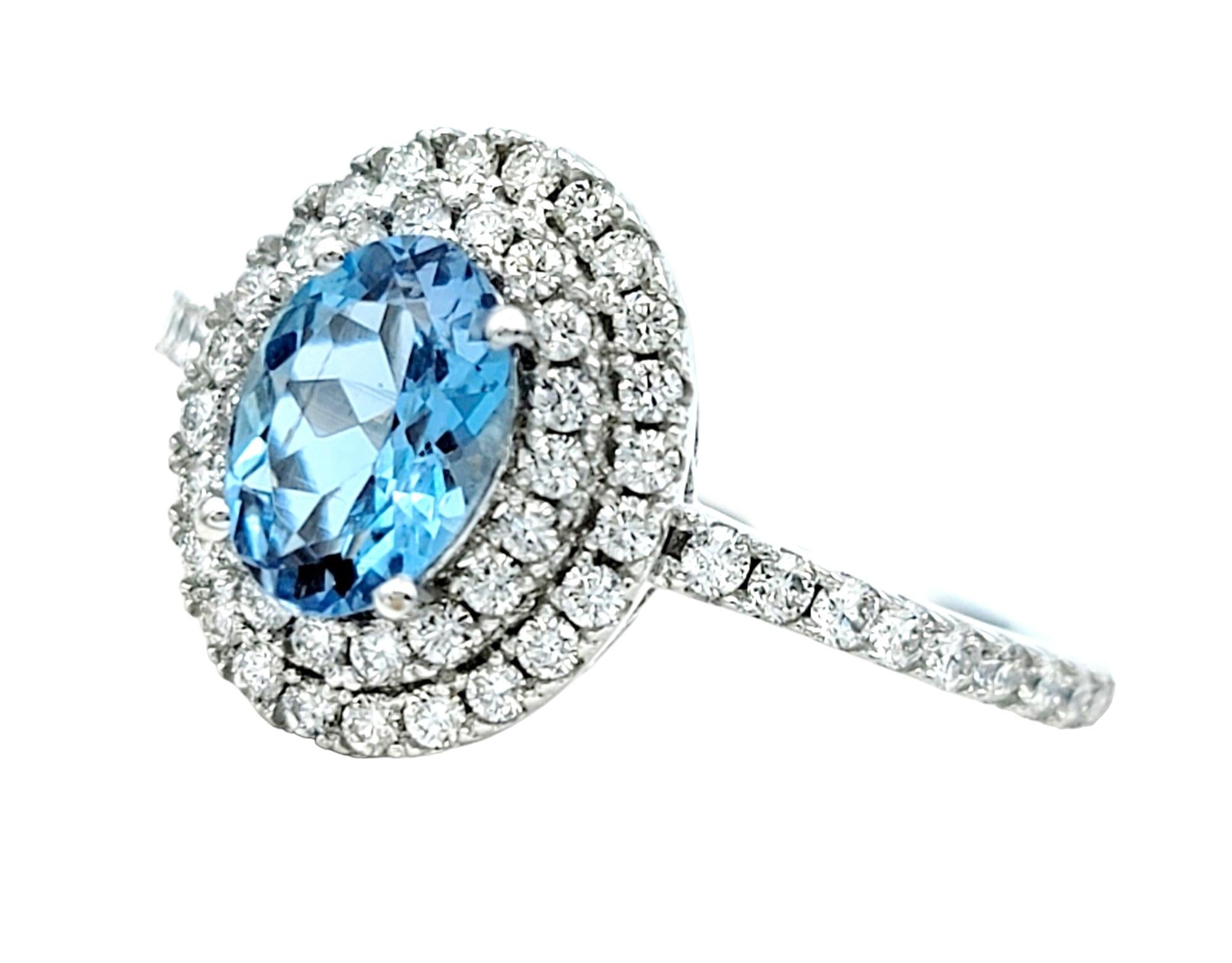 Contemporary Oval Cut Aquamarine and Pavé Diamond Double Halo Ring Set in 18 Karat White Gold For Sale