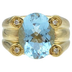 Anello cocktail con acquamarina taglio ovale e accenti di diamante in oro giallo 18 carati
