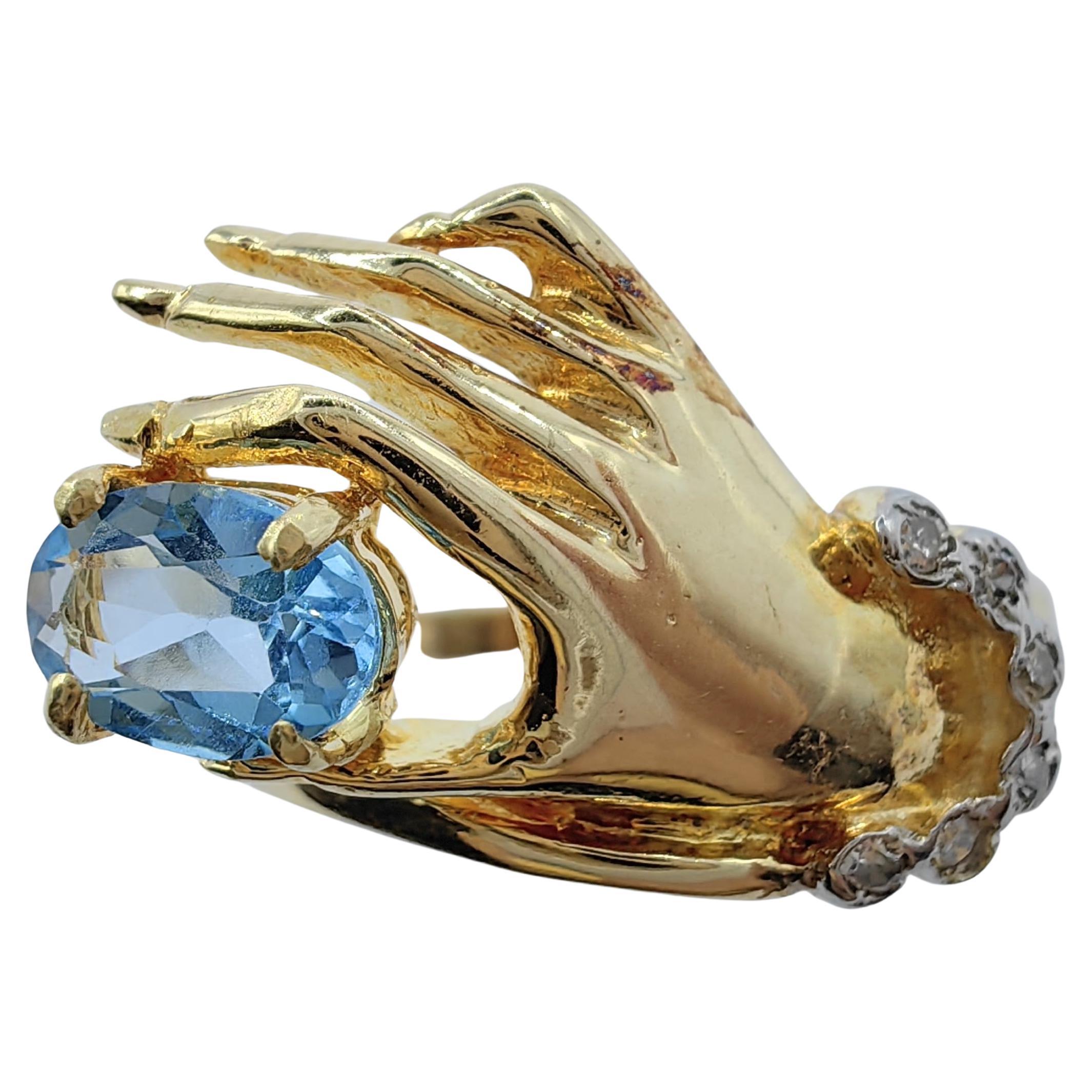 Oval-cut Blue Topaz in a Hand Diamond Ring in 14K Yellow Gold For Sale