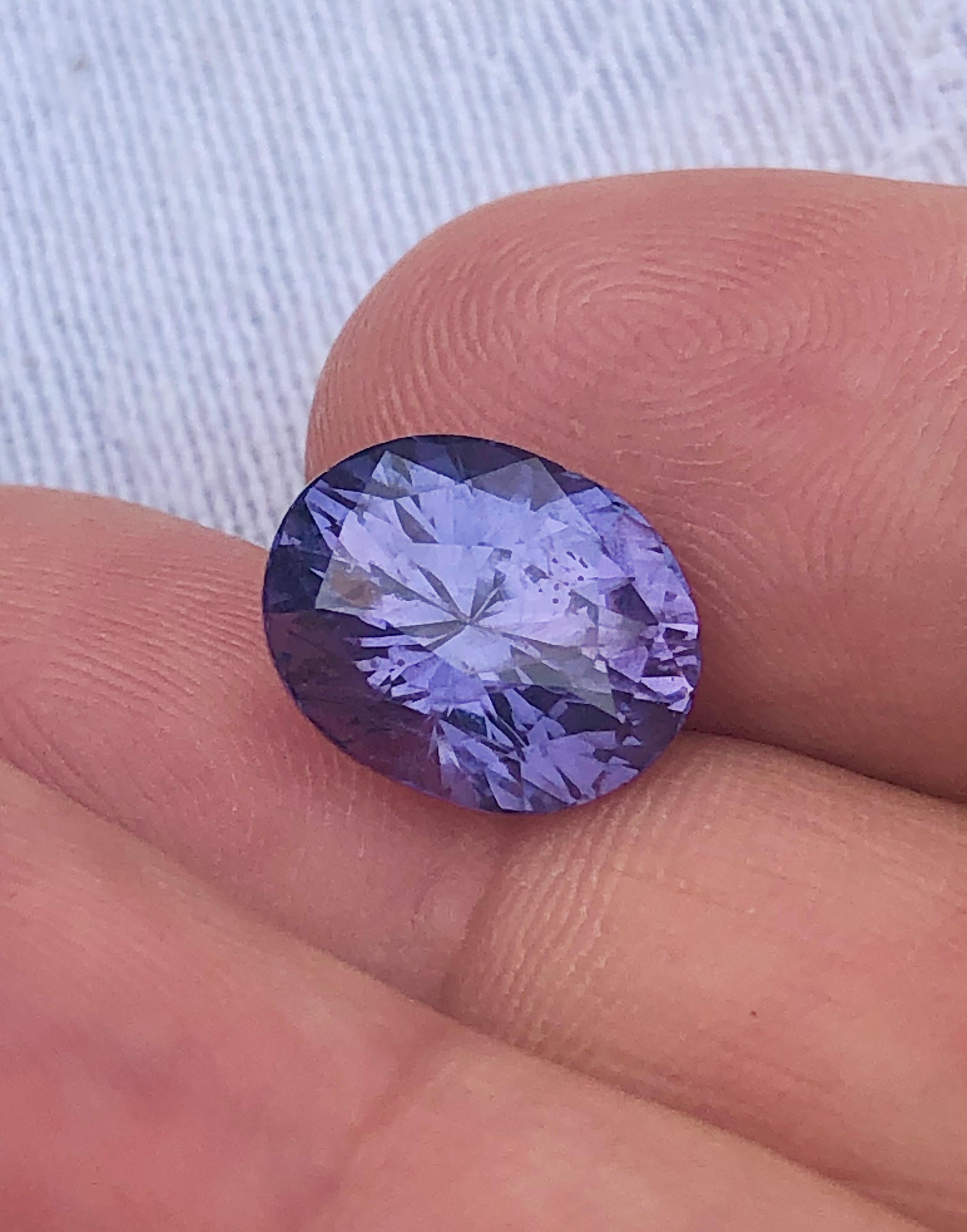 Stunning color Violet Purple Spinel soft sculpture bezel ring that has a 6.09 carat; measurement of 12.10mm x 9.60mm oval cut 