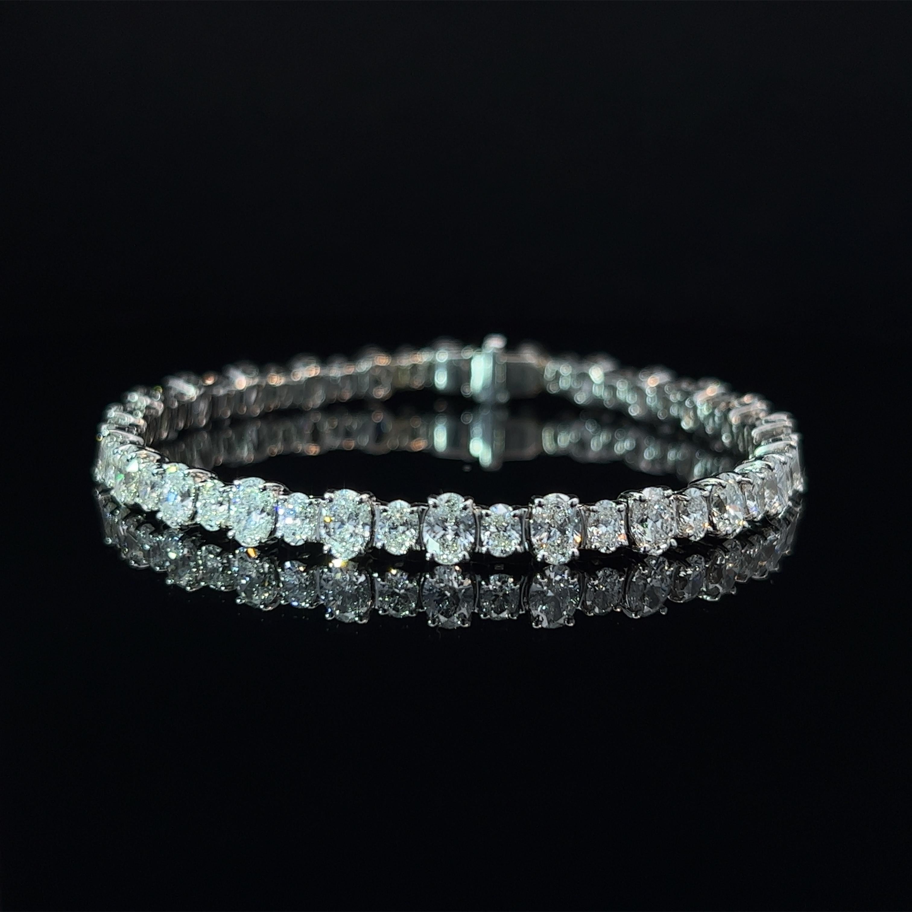 Diamond Shape: Oval Cut 
Total Diamond Weight: 10.51ct
Individual Diamond Weight: .33ct & .15ct
Color/Clarity: FG VVS  
Metal: 18K White Gold  
Metal Weight: 15.33g 

Key Features:

Oval-Cut Diamonds: The centerpiece of this bracelet showcases a