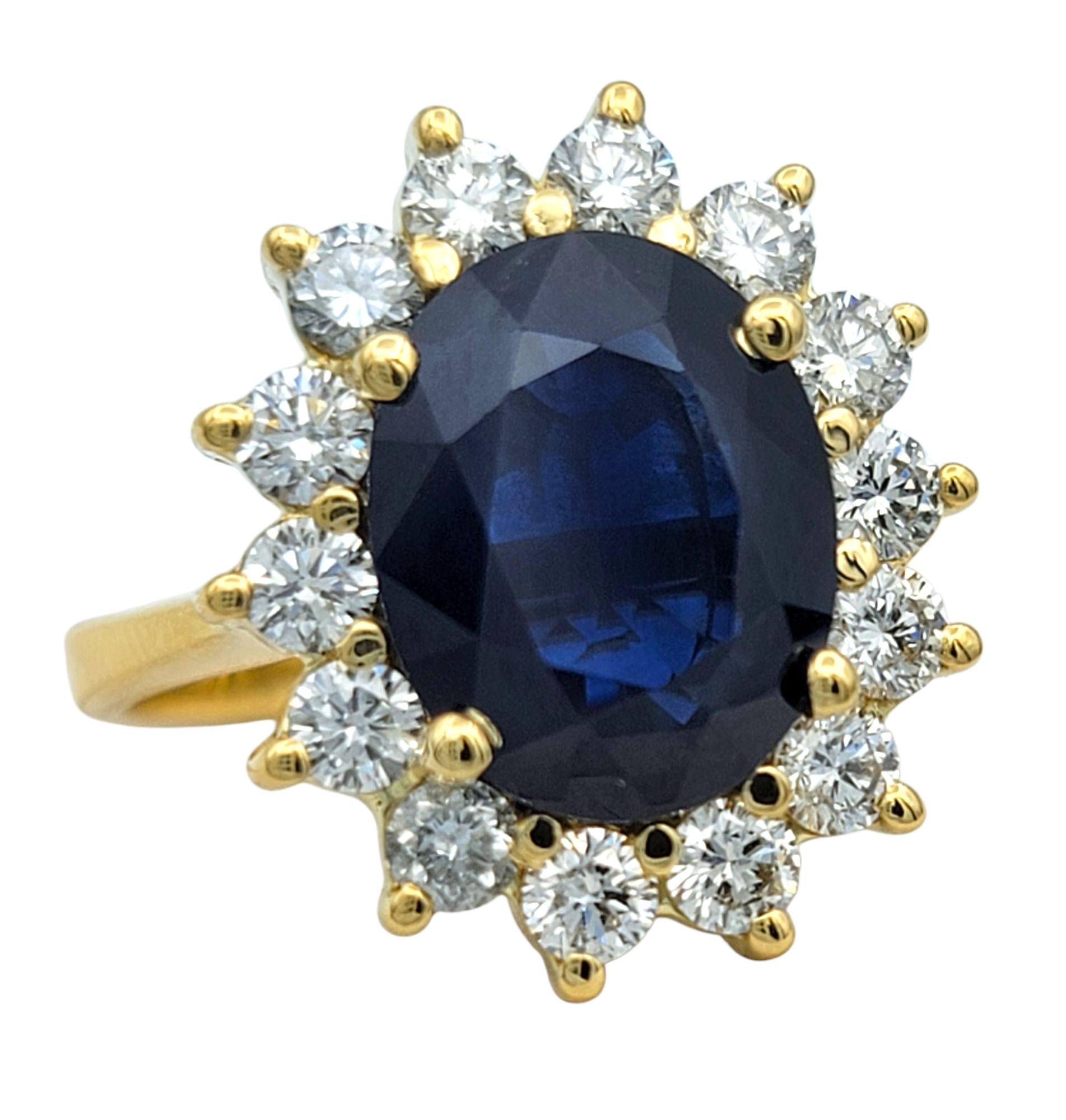 Taille de l'anneau : 7

Cette bague de cocktail d'une beauté classique est ornée d'un saphir bleu profond de 3,39 carats taillé en ovale au centre. Le saphir est fixé dans une monture à griffes en or jaune et entouré d'un halo de diamants ronds de