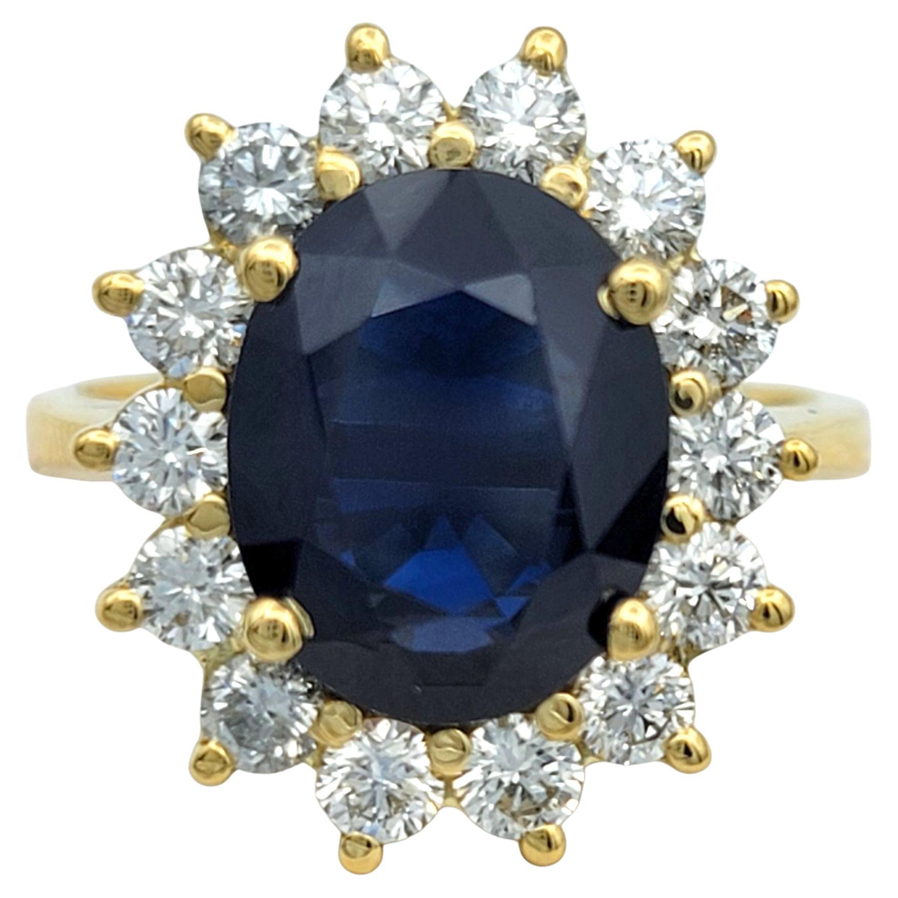 Oval Cut Blue Sapphire and Diamond Halo Cocktail Ring in 18 Karat Yellow Gold