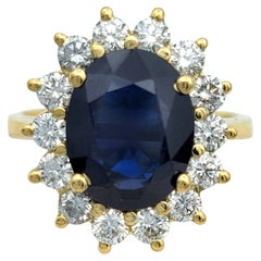 Oval Cut Blue Sapphire and Diamond Halo Cocktail Ring in 18 Karat Yellow Gold