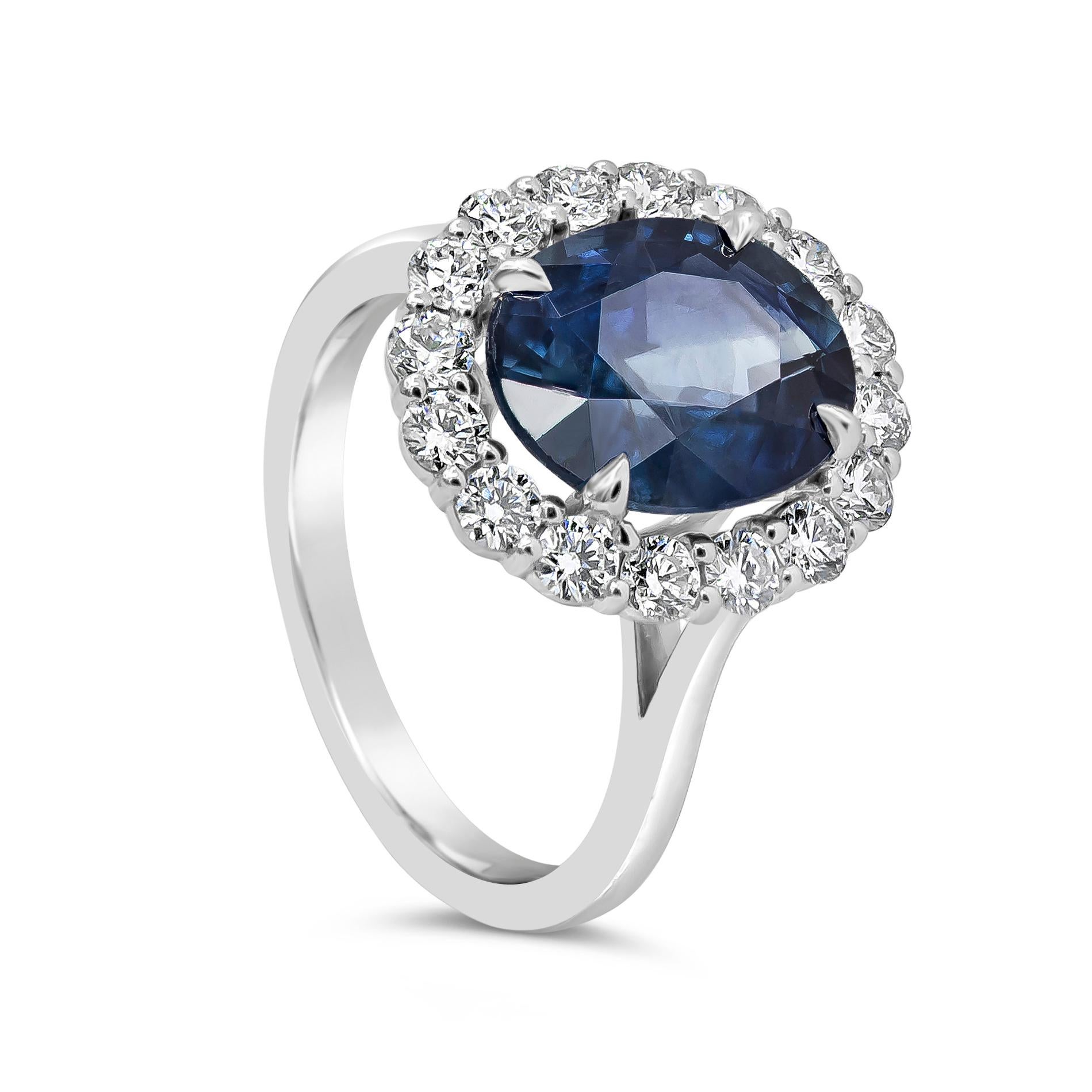 Showcasing a 4.40 carat oval cut blue sapphire, elegantly set in a brilliant diamond halo weighing 0.85 carats total. Set it in an 18 karat white gold mounting. Size 7 US. 

Style available in different price ranges. Prices are based on your