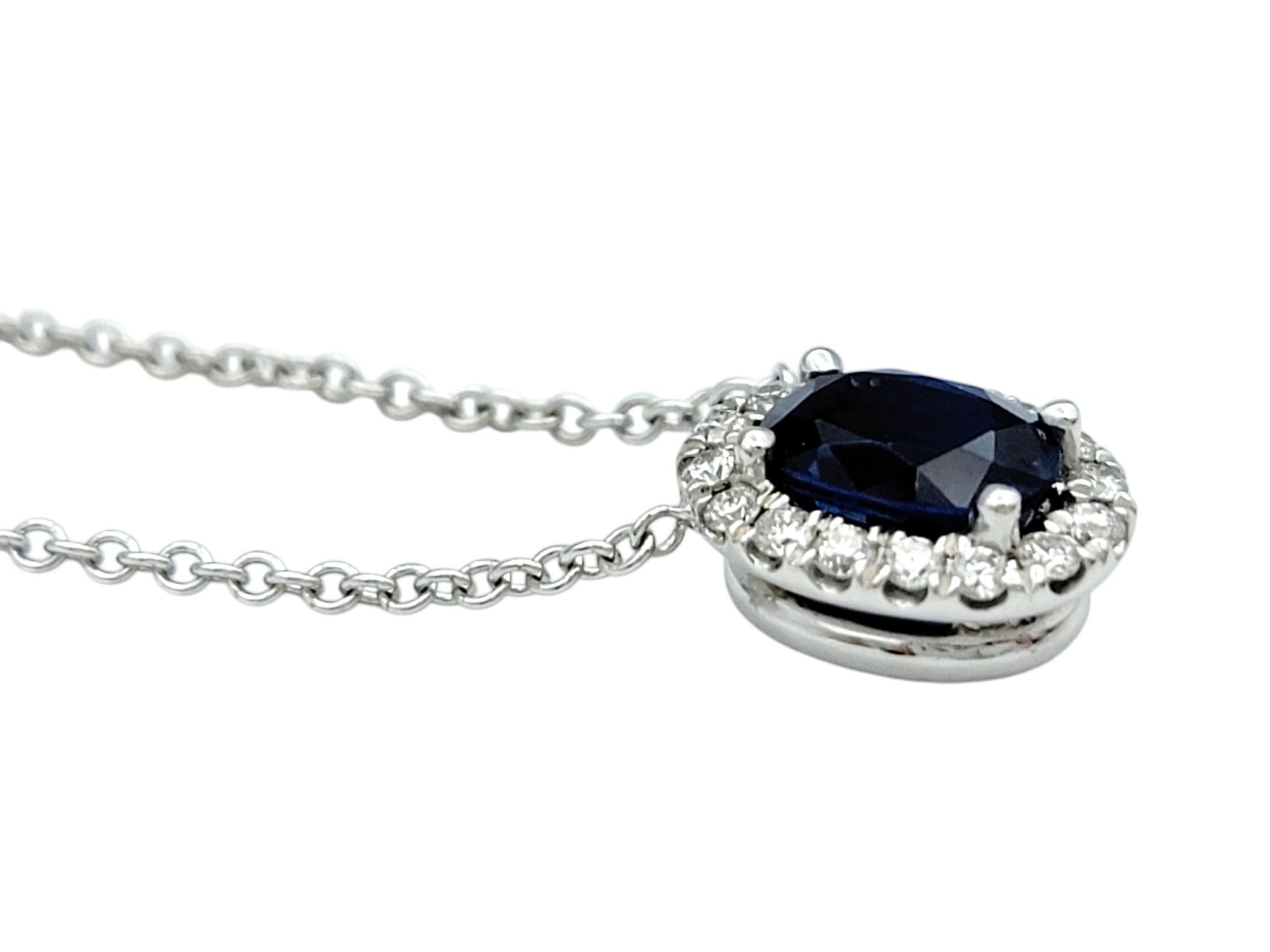 Women's Oval Cut Blue Sapphire and Diamond Halo Pendant Necklace in 18 Karat White Gold For Sale