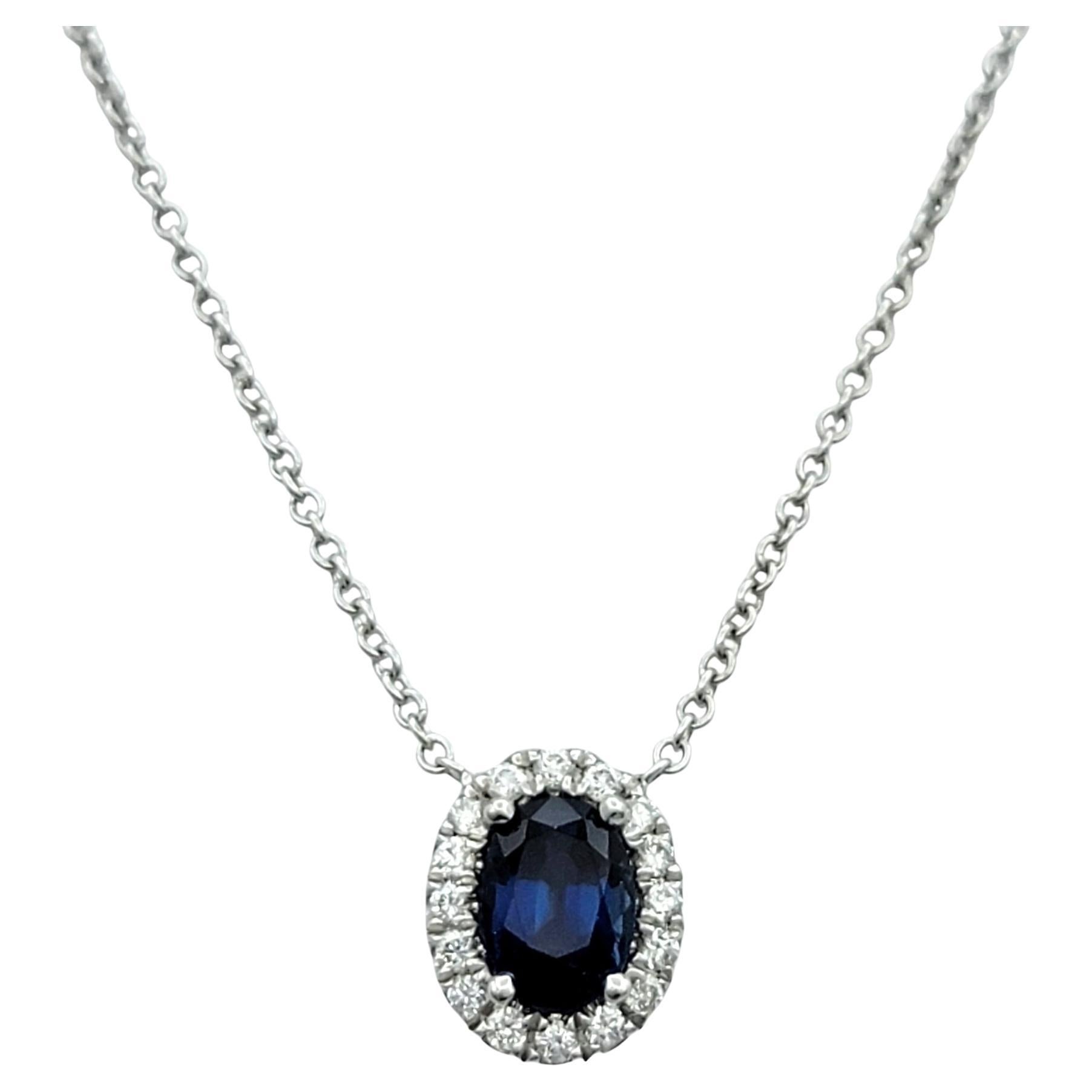 Oval Cut Blue Sapphire and Diamond Halo Pendant Necklace in 18 Karat White Gold