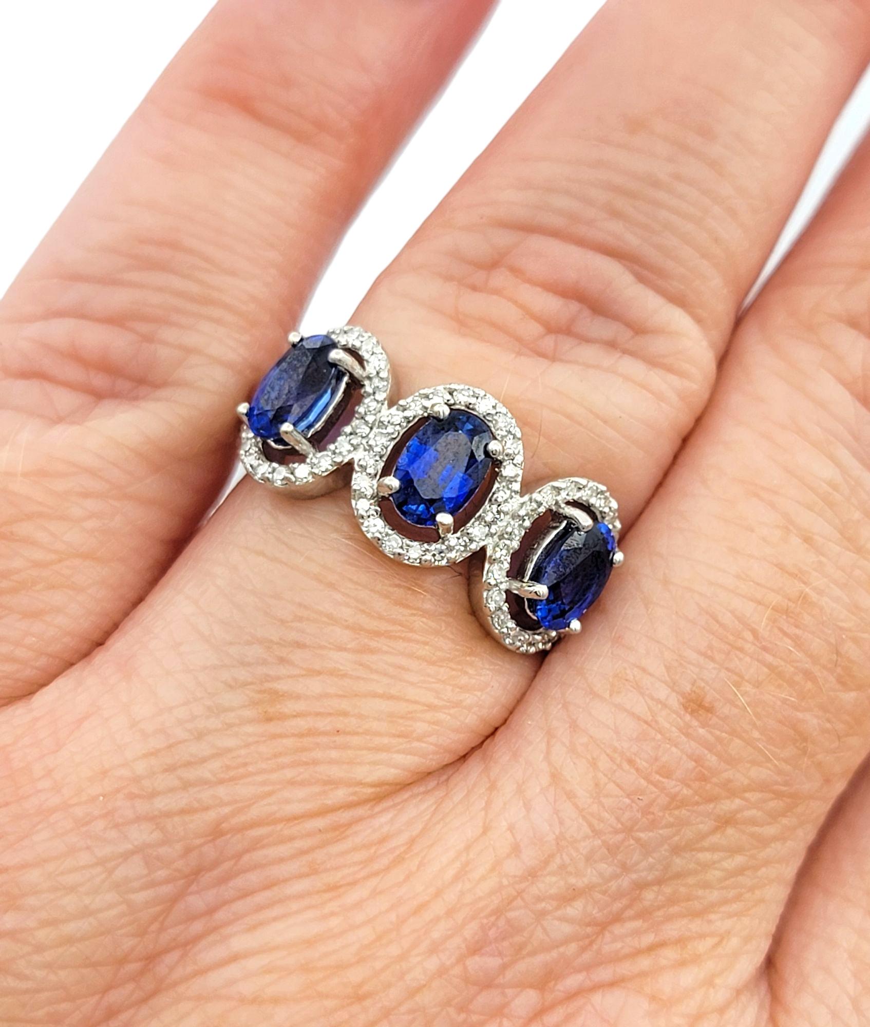 Oval Cut Blue Sapphire and Diamond Halo Three Stone Ring in 18 Karat White Gold For Sale 5