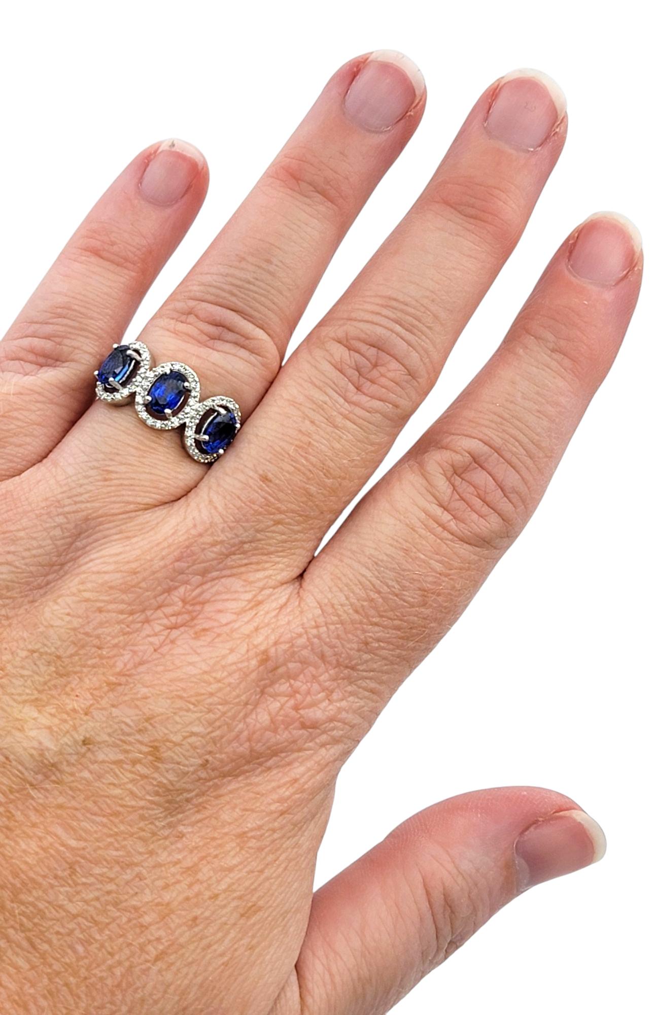 Oval Cut Blue Sapphire and Diamond Halo Three Stone Ring in 18 Karat White Gold For Sale 6