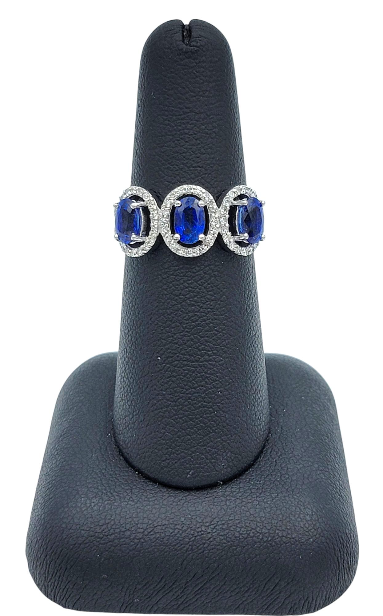 Oval Cut Blue Sapphire and Diamond Halo Three Stone Ring in 18 Karat White Gold For Sale 7