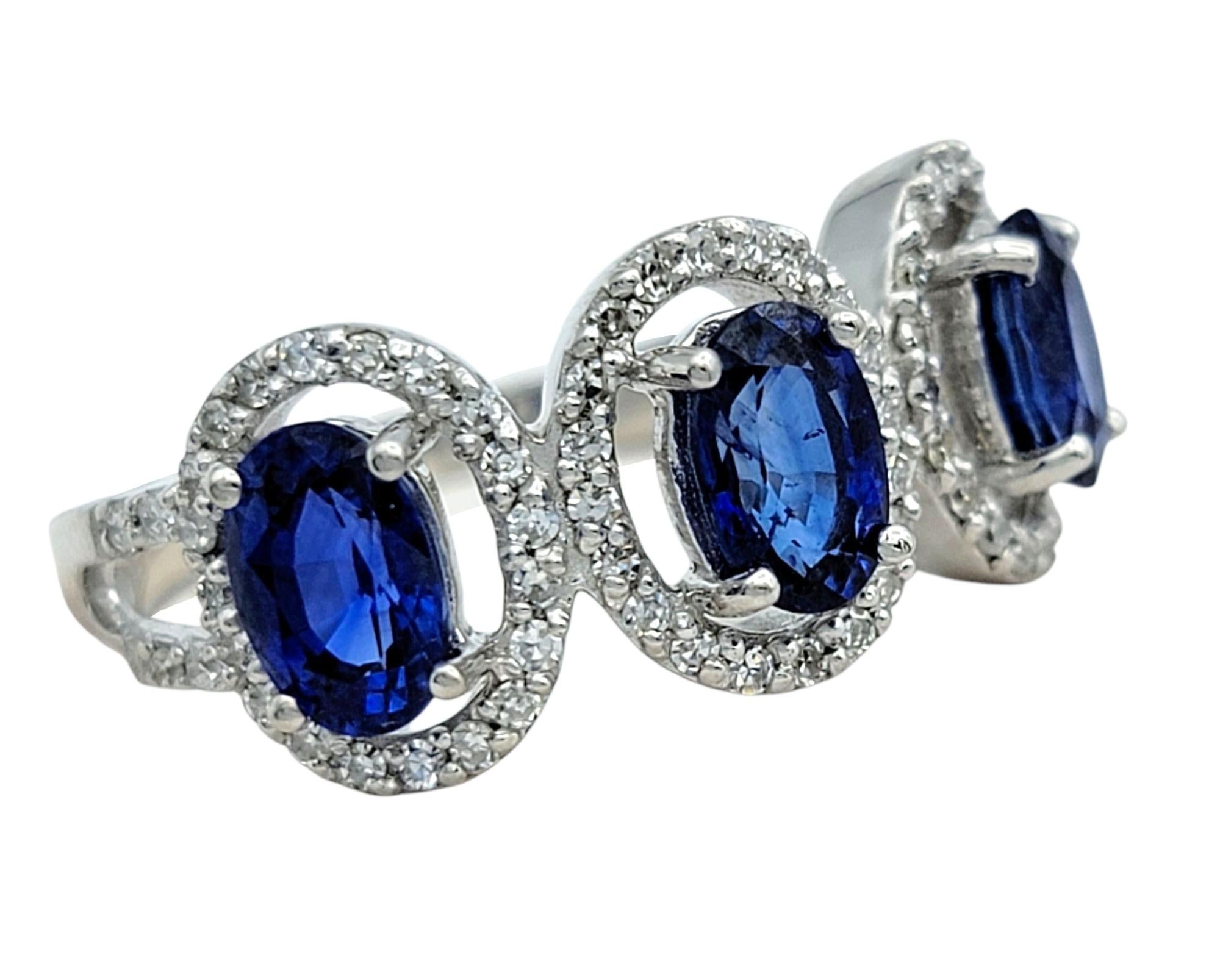 Oval Cut Blue Sapphire and Diamond Halo Three Stone Ring in 18 Karat White Gold In Good Condition For Sale In Scottsdale, AZ