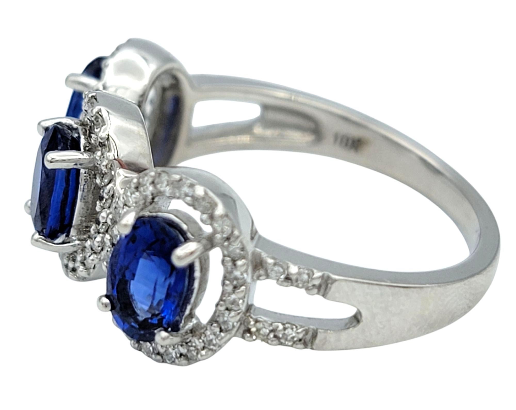 Oval Cut Blue Sapphire and Diamond Halo Three Stone Ring in 18 Karat White Gold For Sale 1
