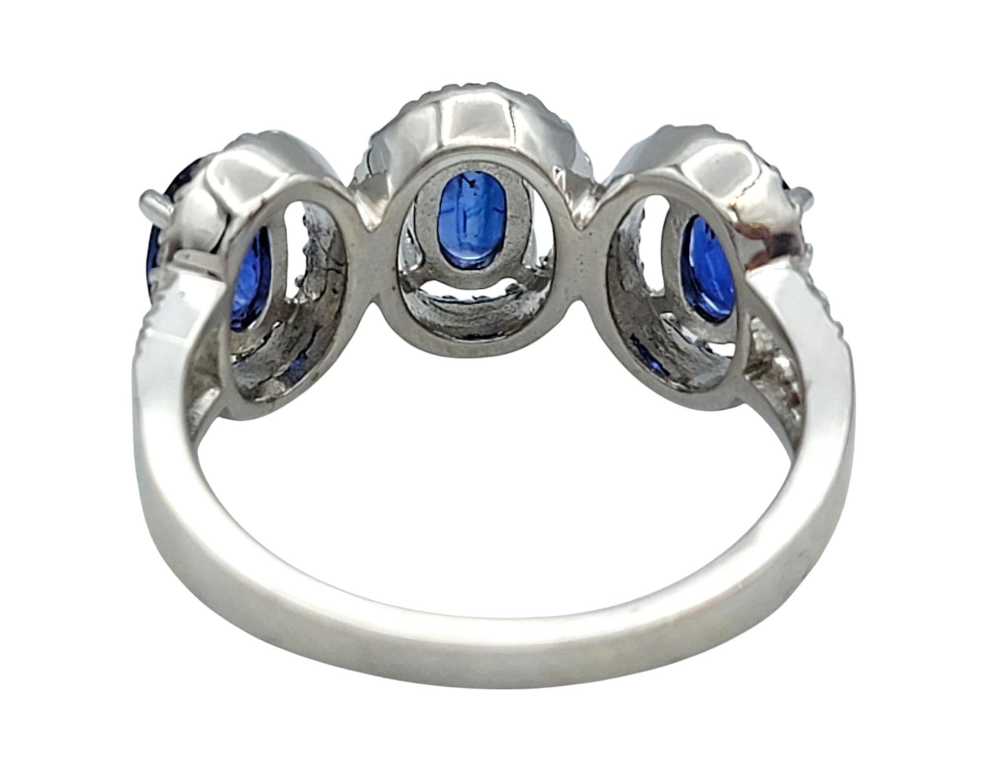 Oval Cut Blue Sapphire and Diamond Halo Three Stone Ring in 18 Karat White Gold For Sale 2