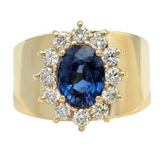 Oval Cut Blue Sapphire and Diamond Halo Wide Band Ring in 14 Karat Yellow Gold